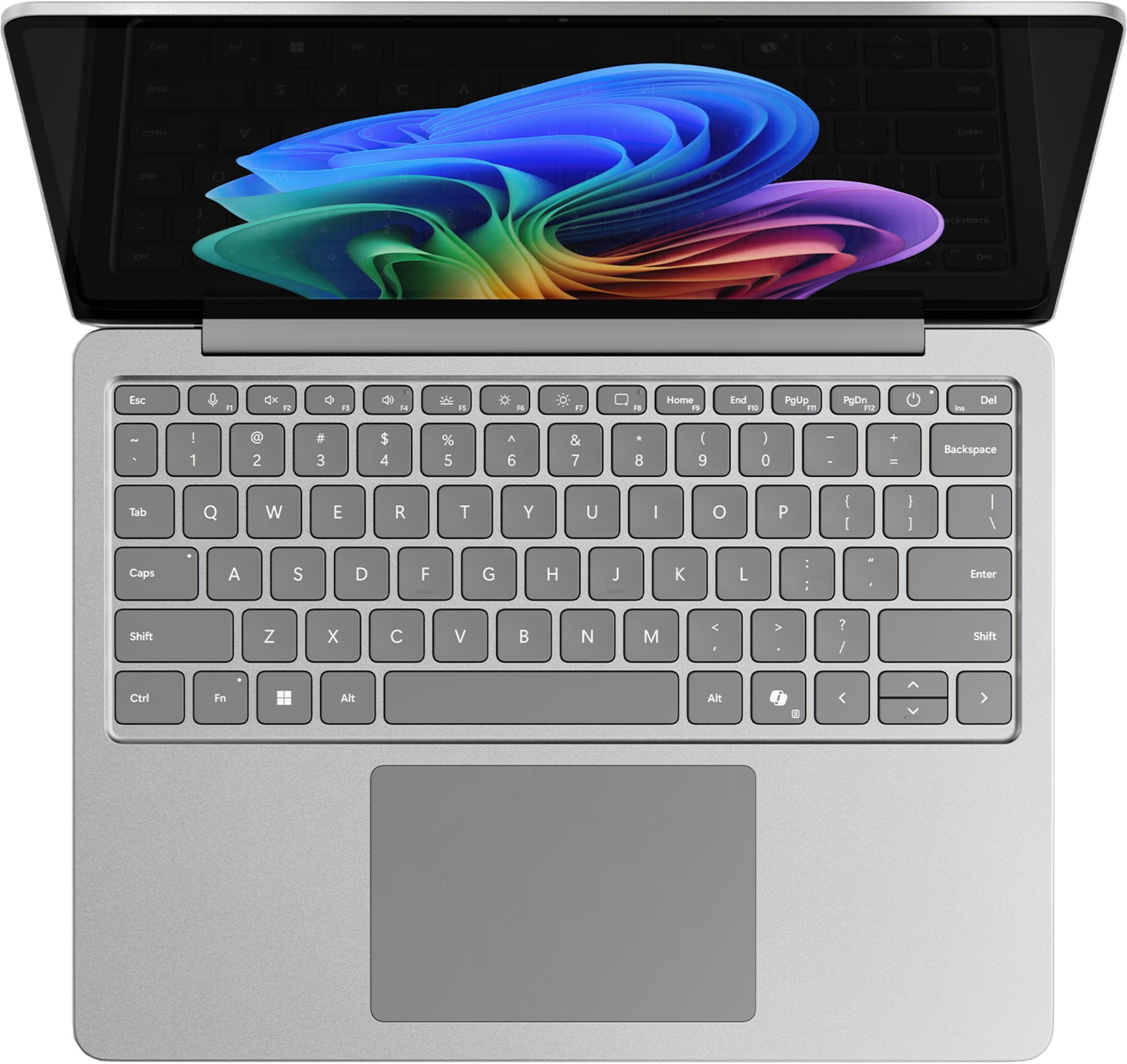 Silberner Laptop mit geöffnetem Bildschirm, der bunte abstrakte Tapete zeigt. Tastatur und Trackpad sichtbar.