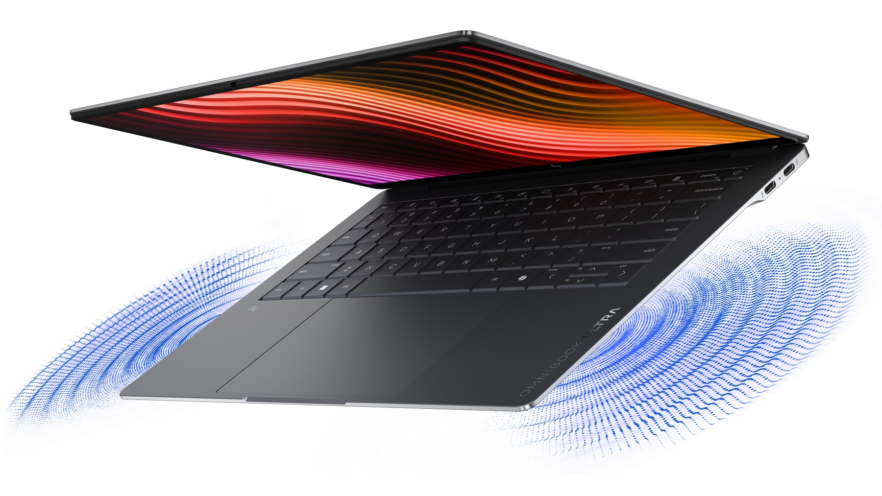 Un laptop aperto con motivo a onde colorate sullo schermo e onde blu.