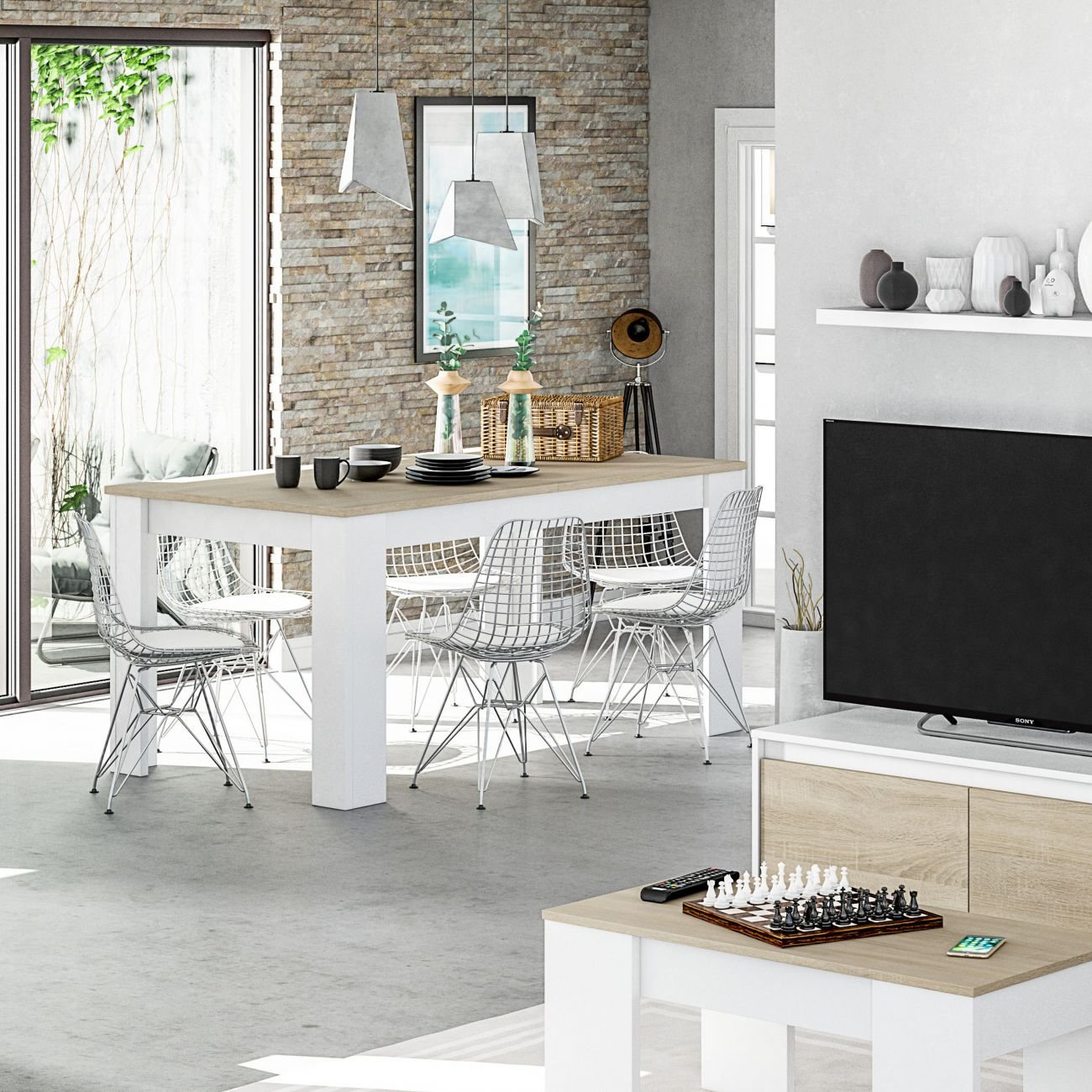 Moderna zona de comedor con mesa blanca, sillas cromadas, pared de acento de piedra y TV.