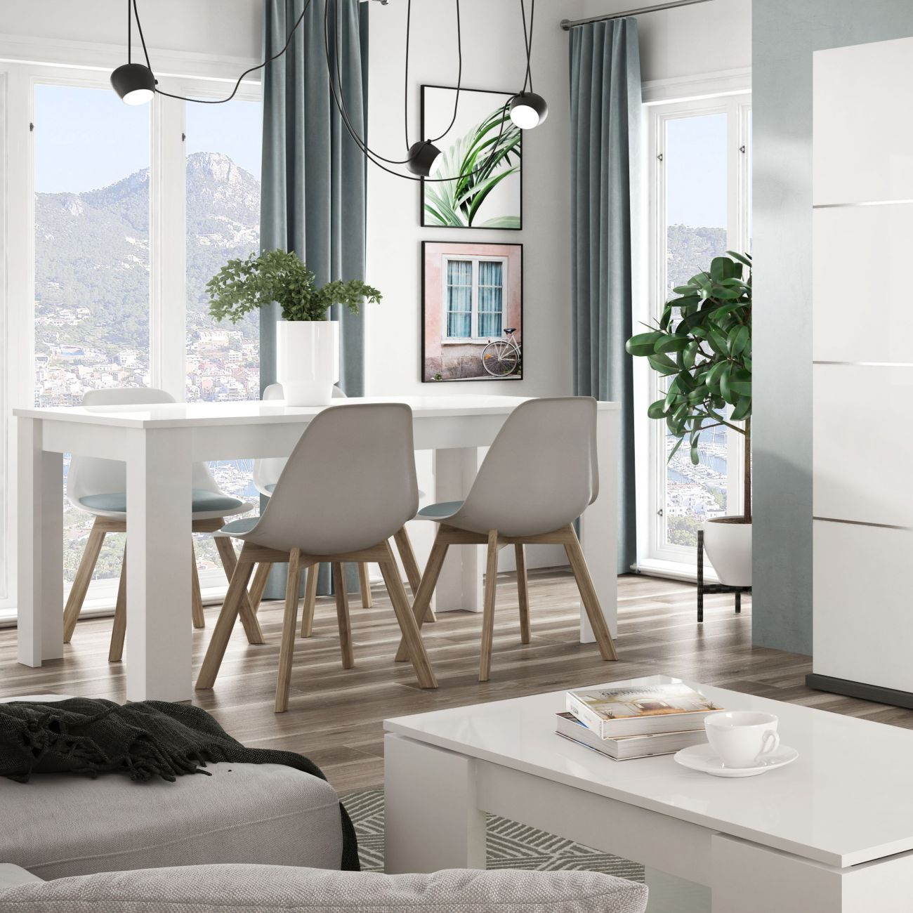 Comedor con mesa blanca, sillas, plantas y paisaje montañoso de fondo.
