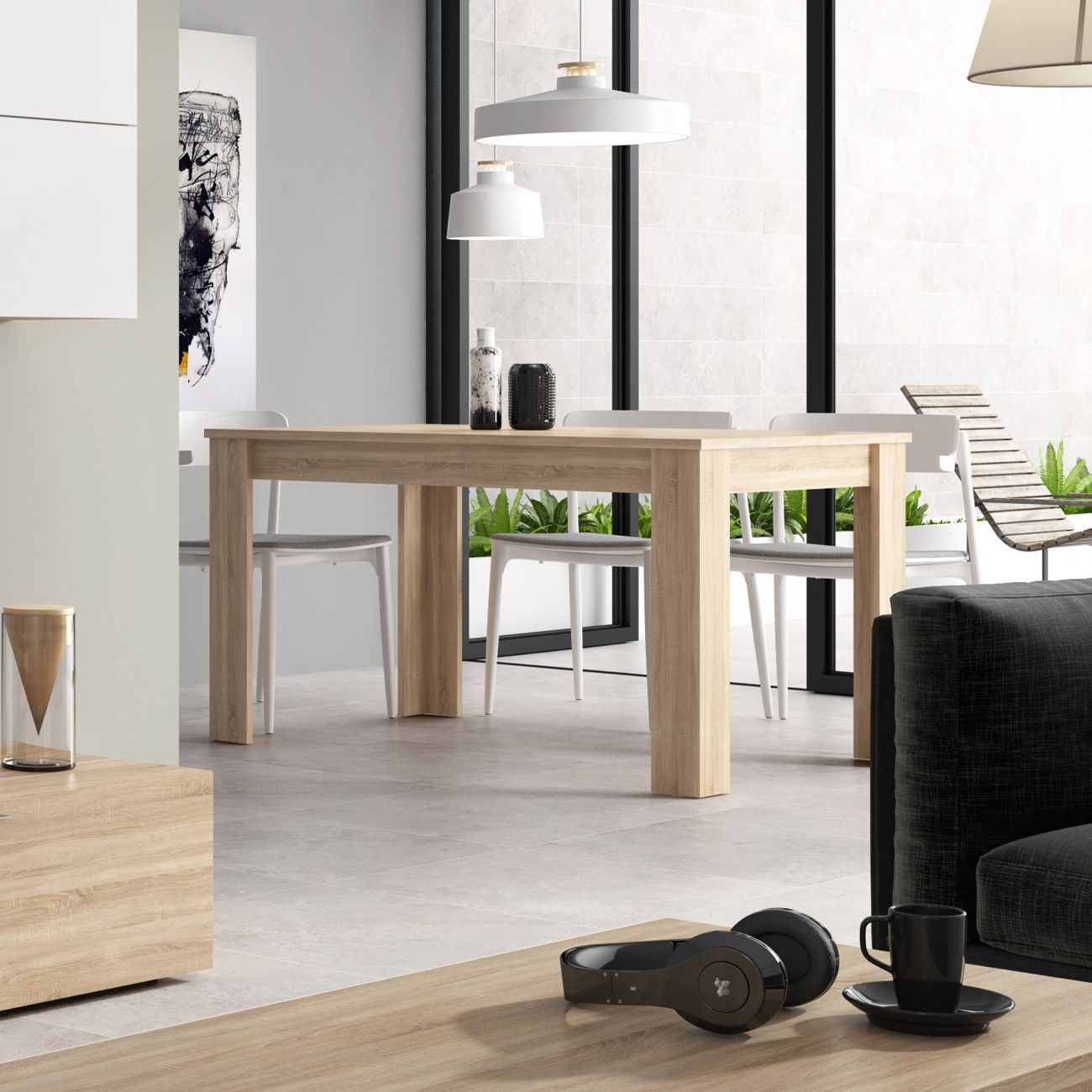 Comedor con mesa de madera, sillas blancas, lámparas y arte moderno.