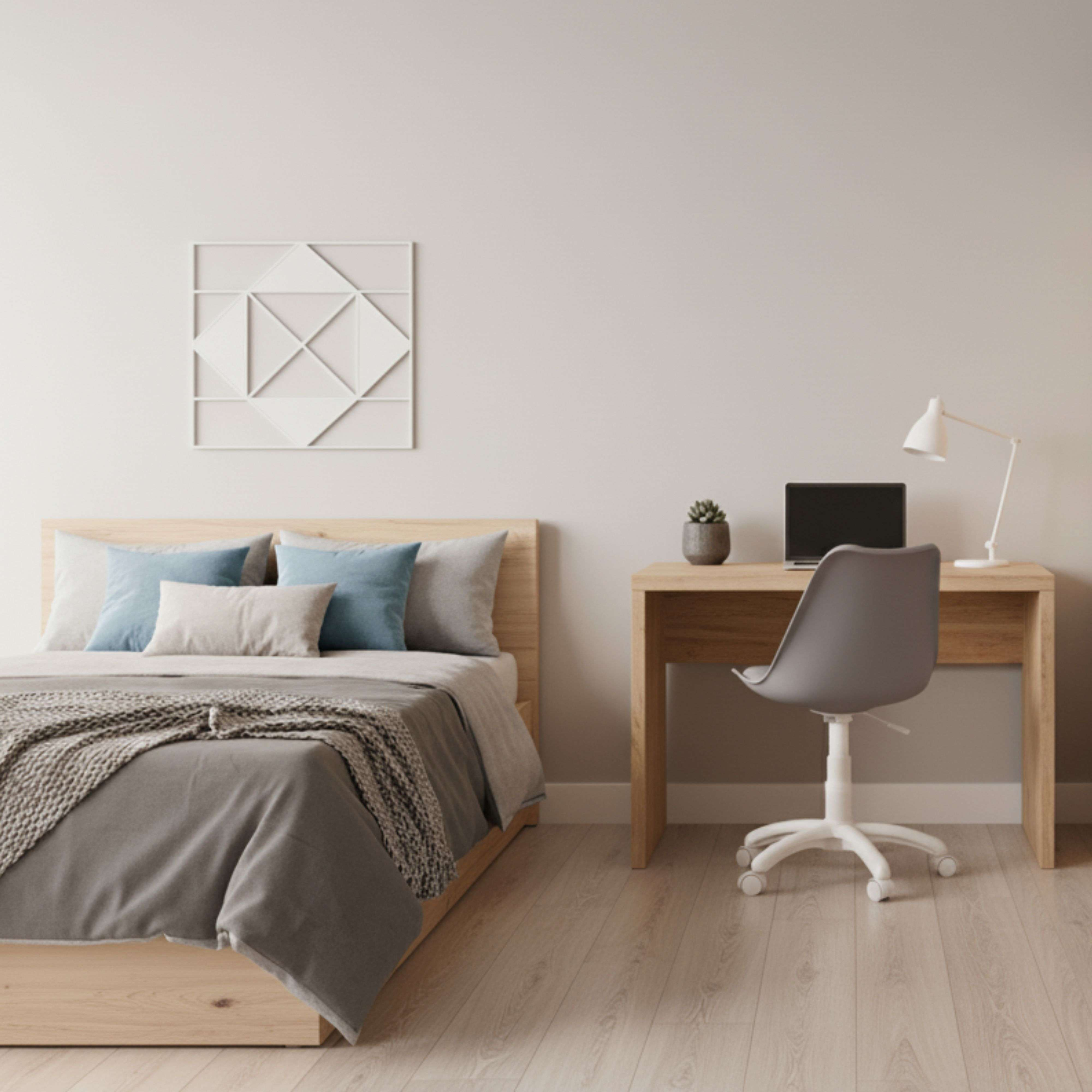 Un dormitorio con cama, escritorio, portátil y silla.