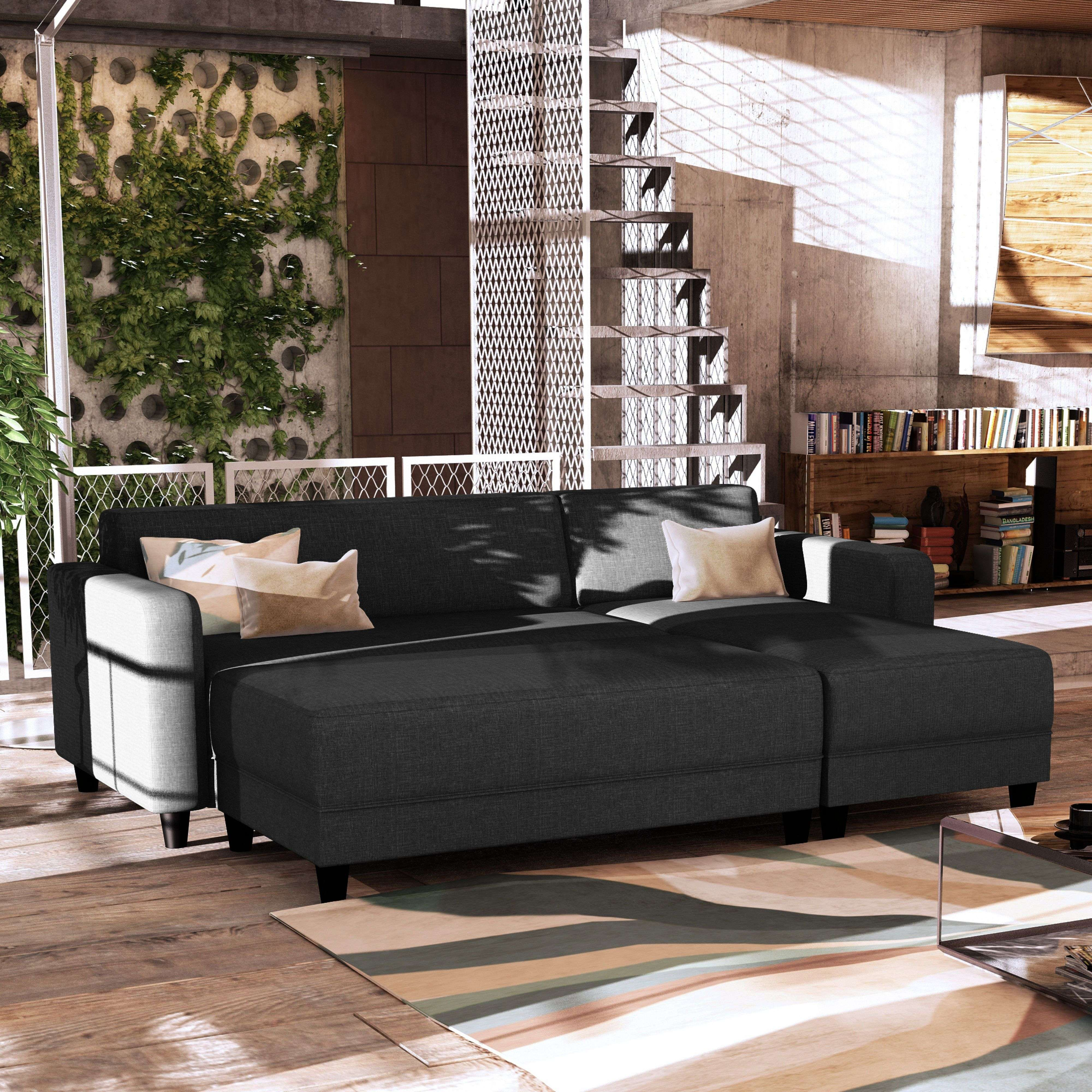 Sofá gris oscuro con mesa auxiliar, estantería y escalera.
