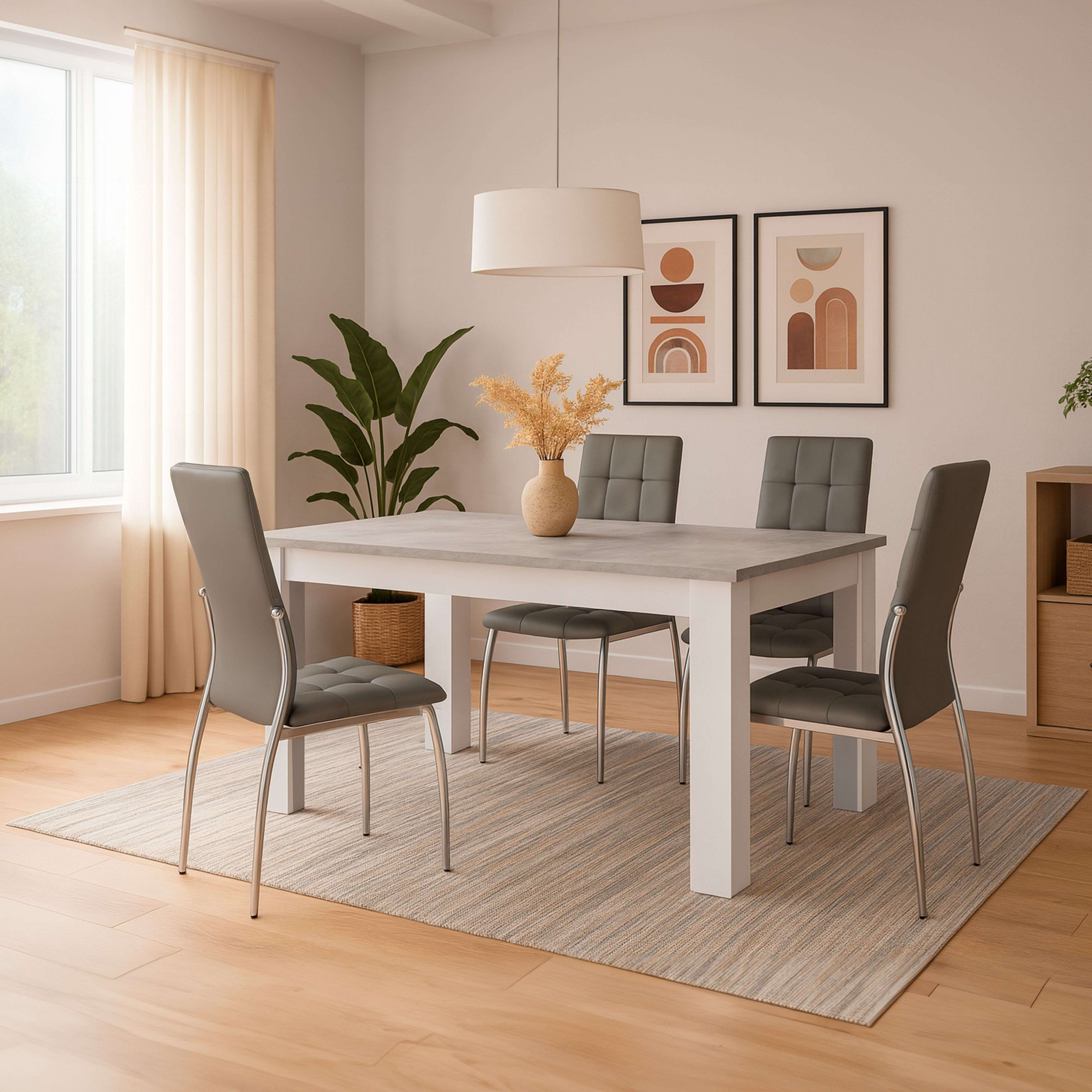 Comedor con mesa, cuatro sillas grises, alfombra, planta y arte en la pared.