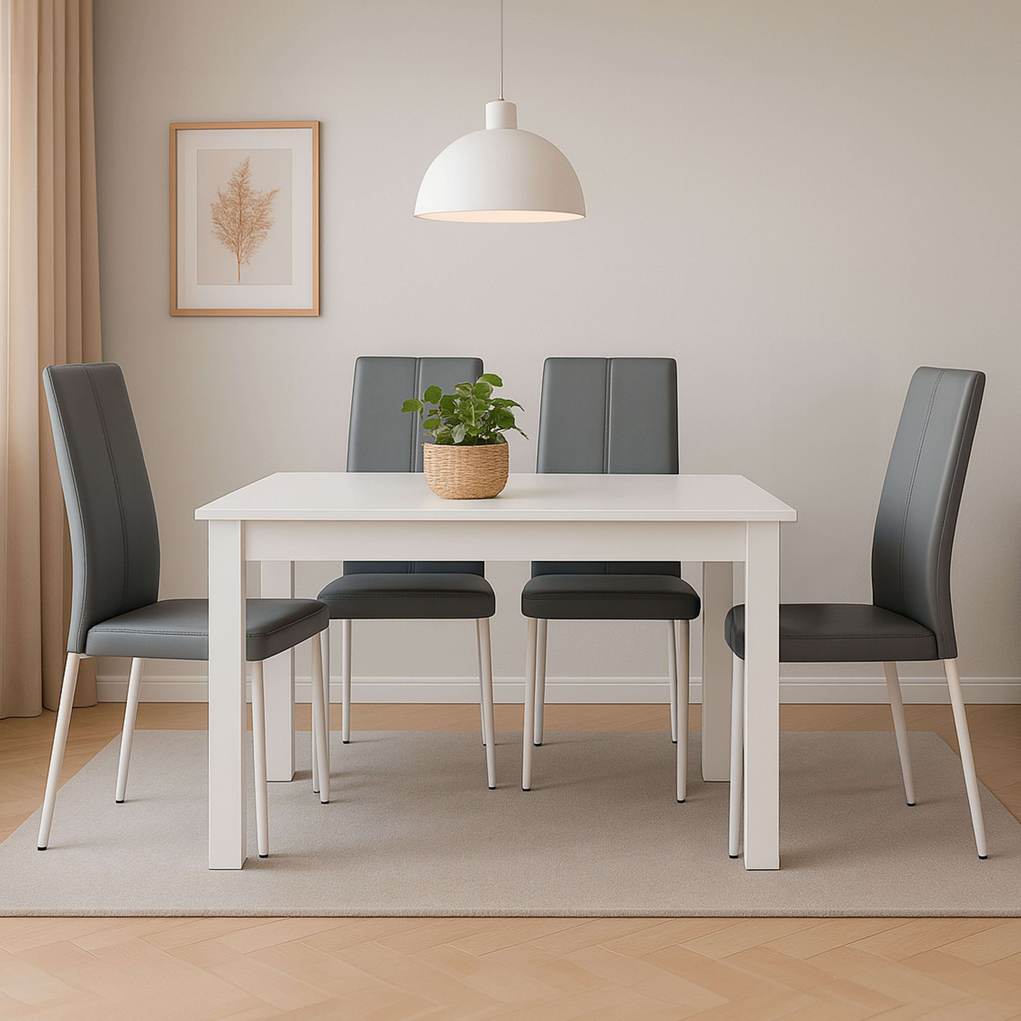 Comedor moderno con mesa blanca, cuatro sillas grises y planta en maceta.