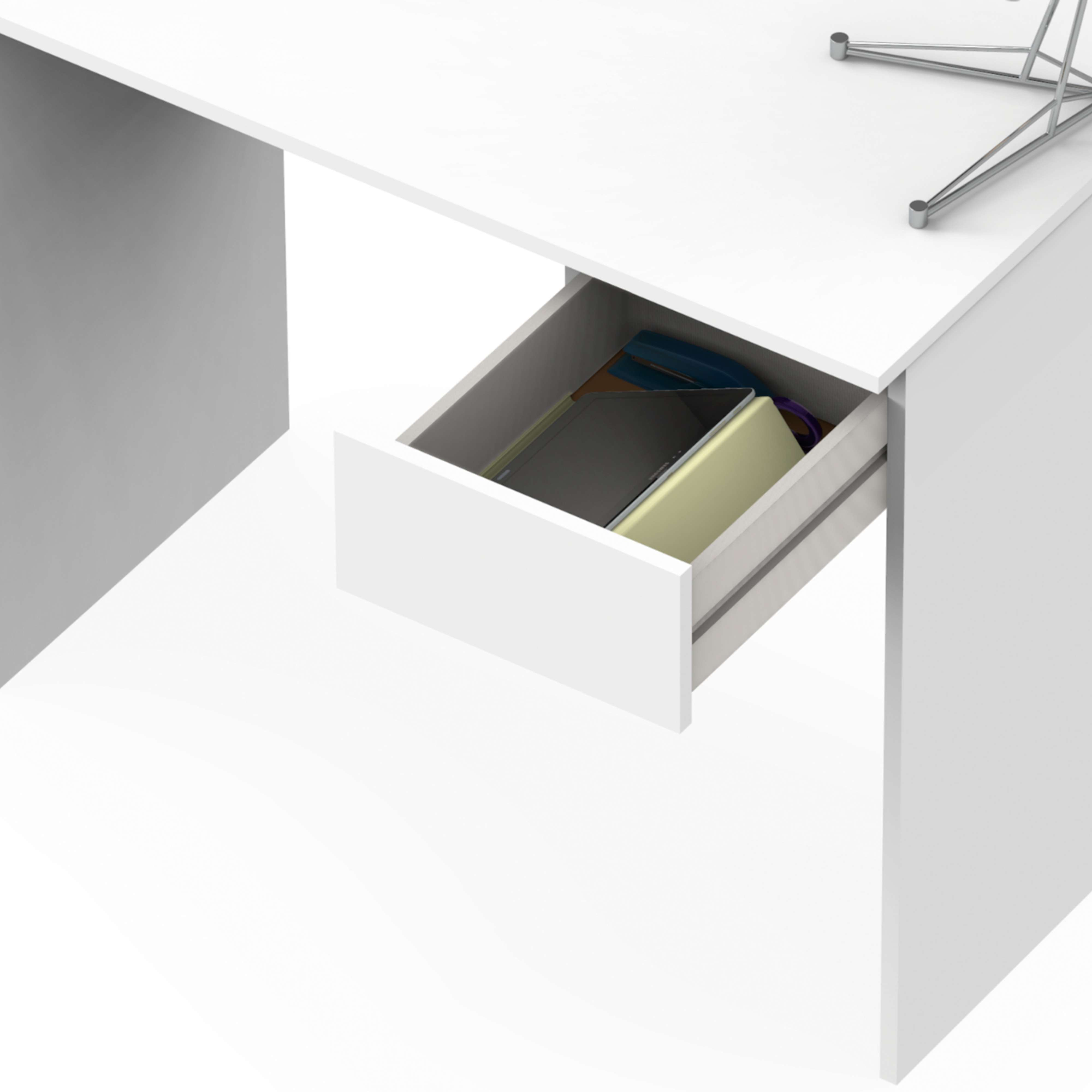 Un escritorio blanco con un cajón abierto que revela libros y una tableta.