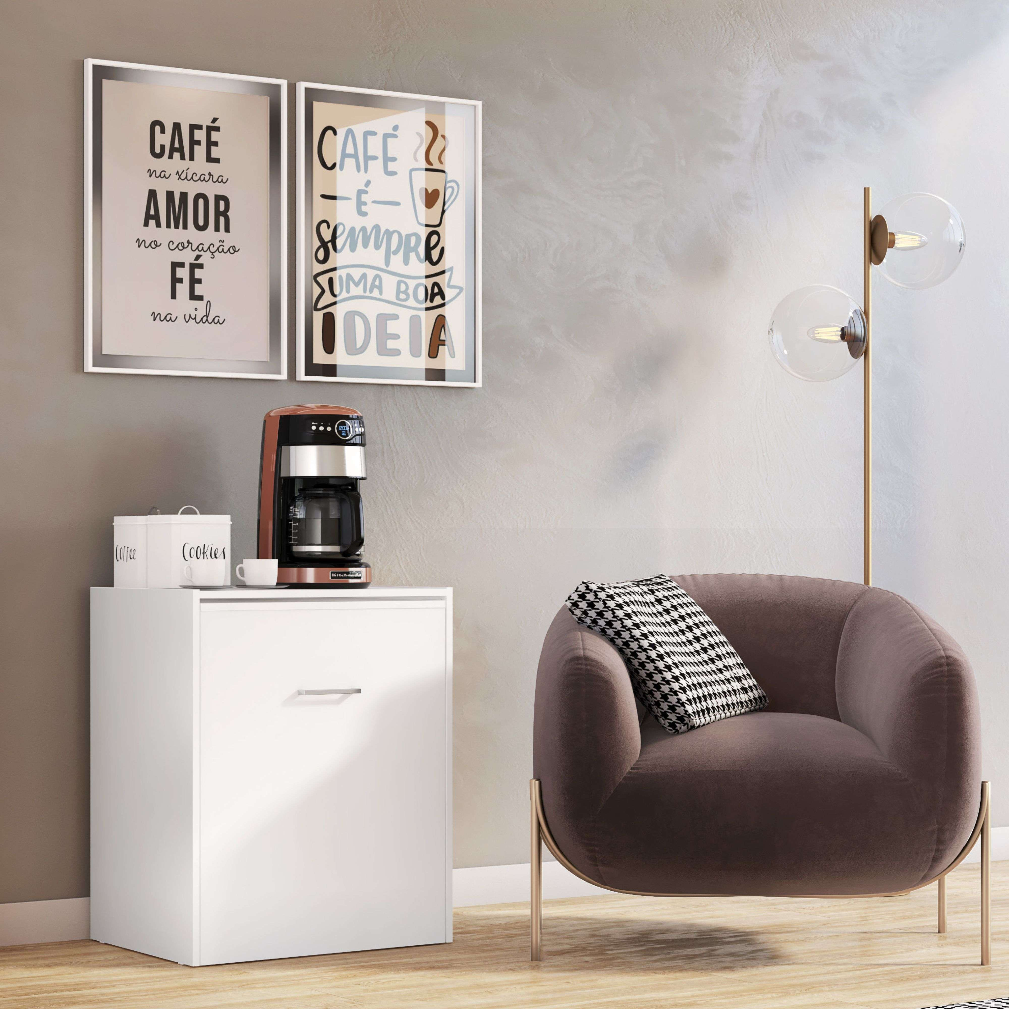 Un sillón marrón con cojines, un armario blanco con cafetera y cuadros.