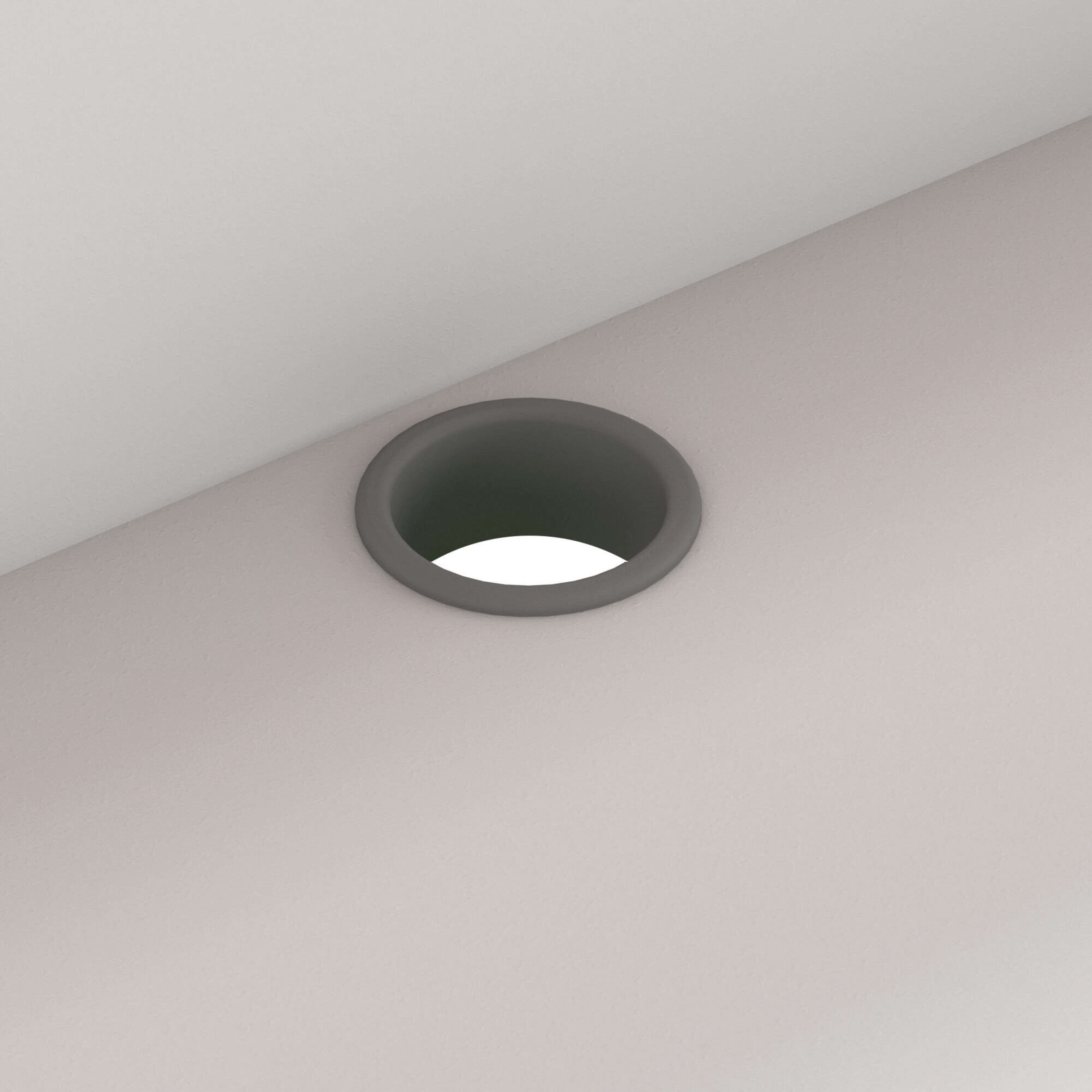Un círculo gris con interior brillante sobre una superficie gris claro.