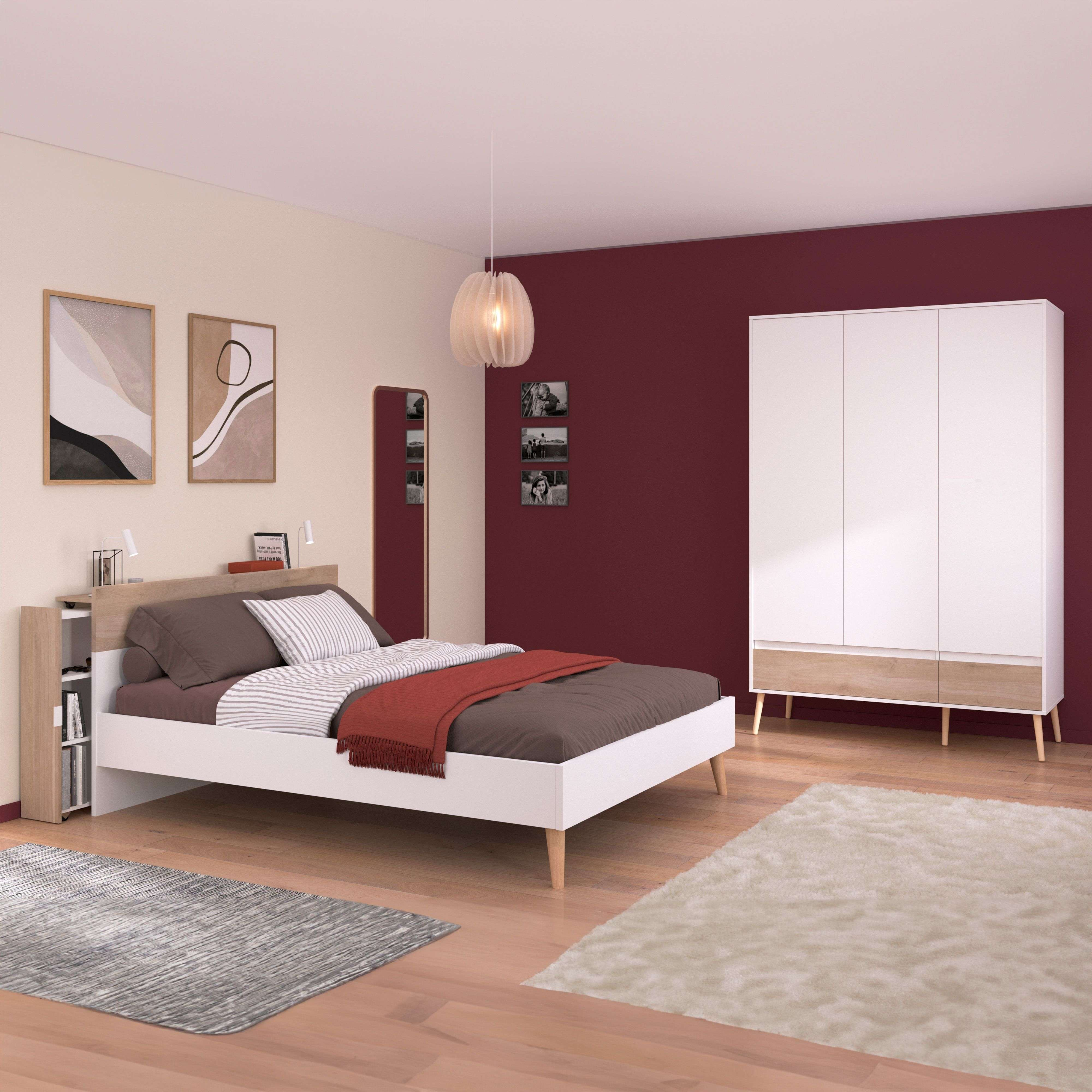 Dormitorio moderno con cama blanca, armario, espejo y cuadros en la pared.