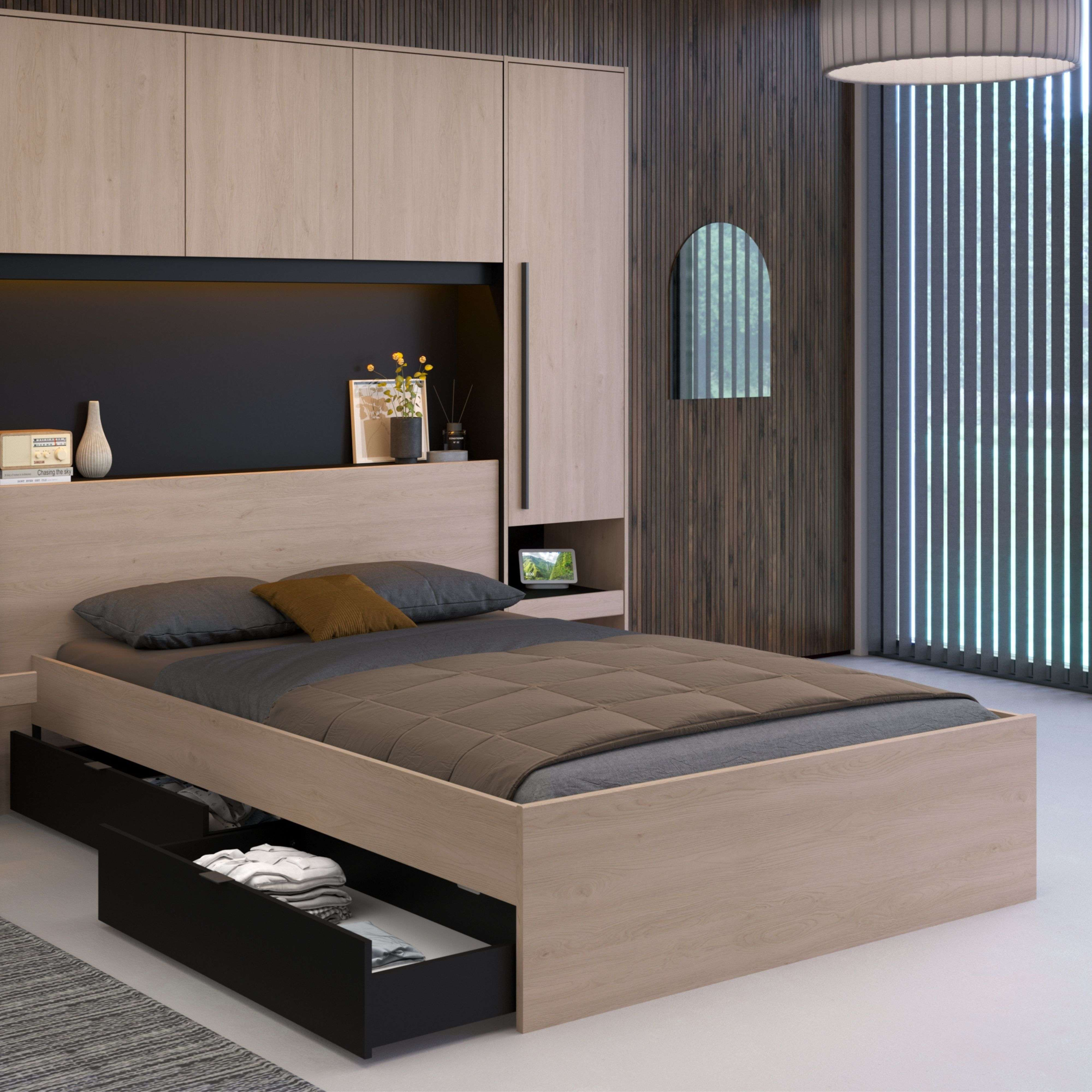 Un dormitorio moderno con cama de madera clara, ropa de cama gris y cajones abiertos.