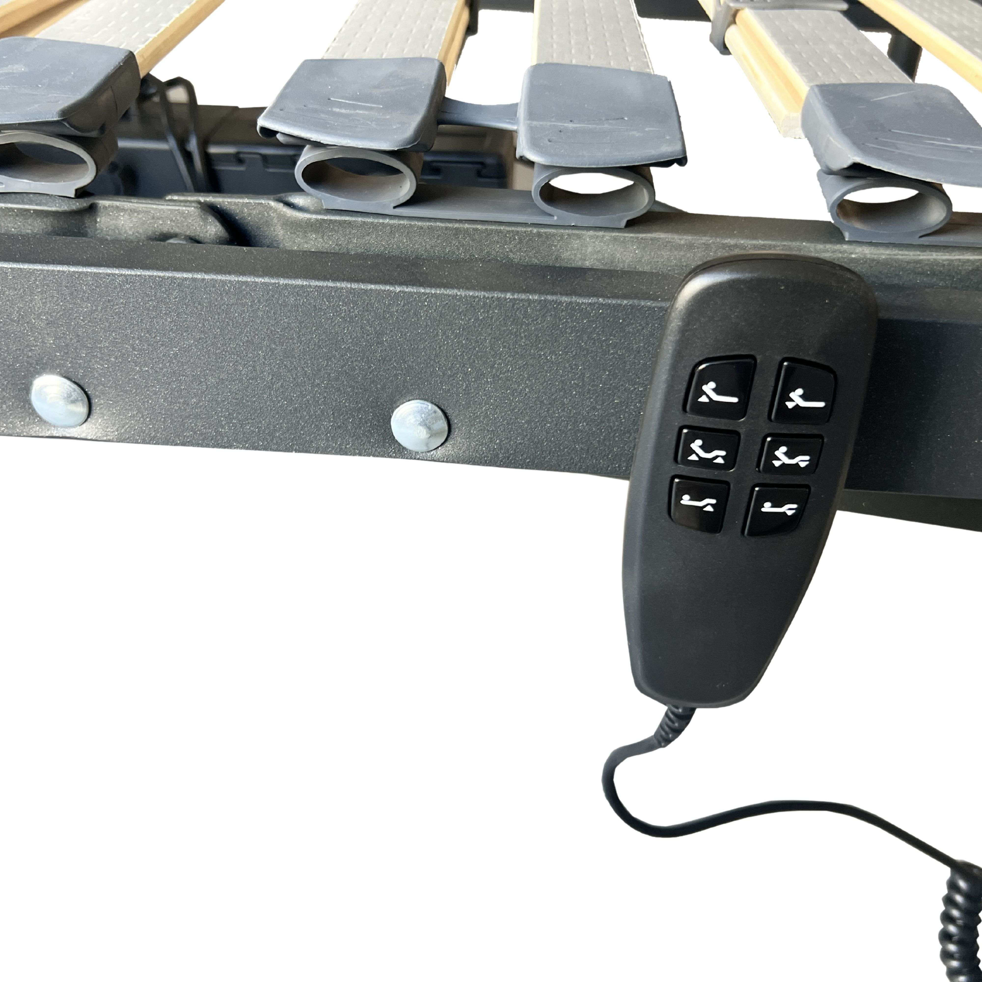 Un bloque de control remoto negro con iconos de posición de cama en un marco de cama.