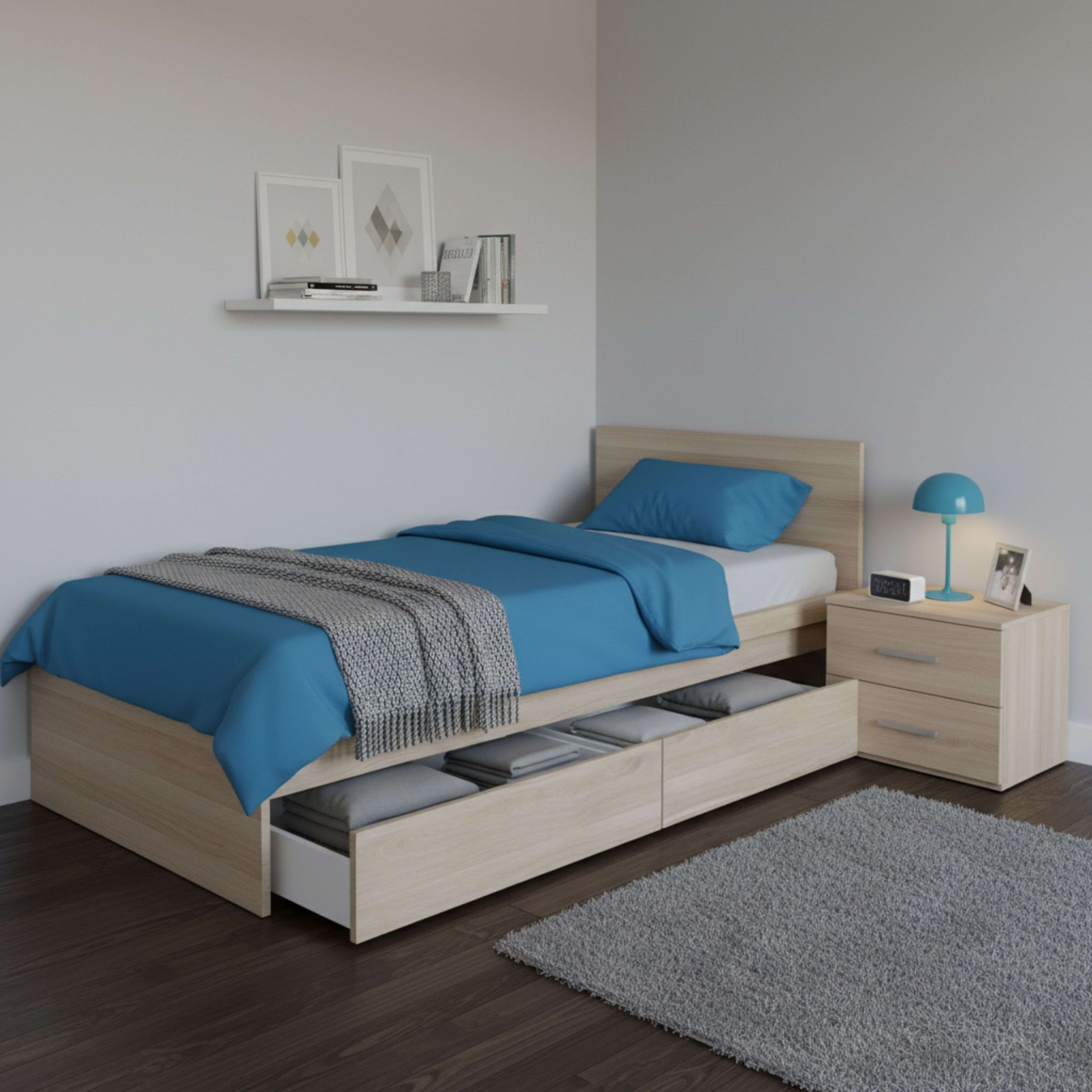 Una cama de madera con ropa de cama azul, manta, cajones y mesita de noche.