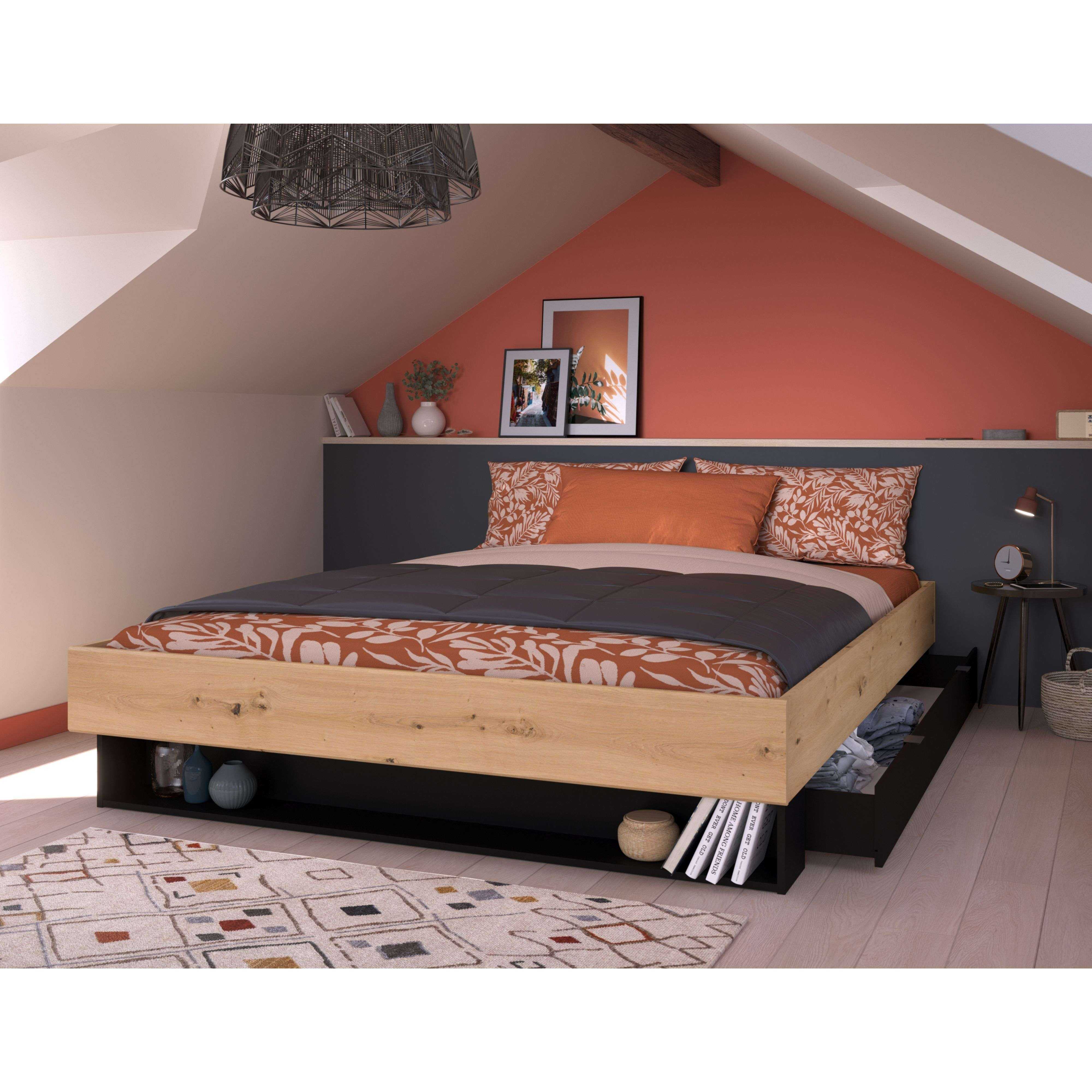 Una cama de madera con ropa de cama naranja y cajones debajo del marco.