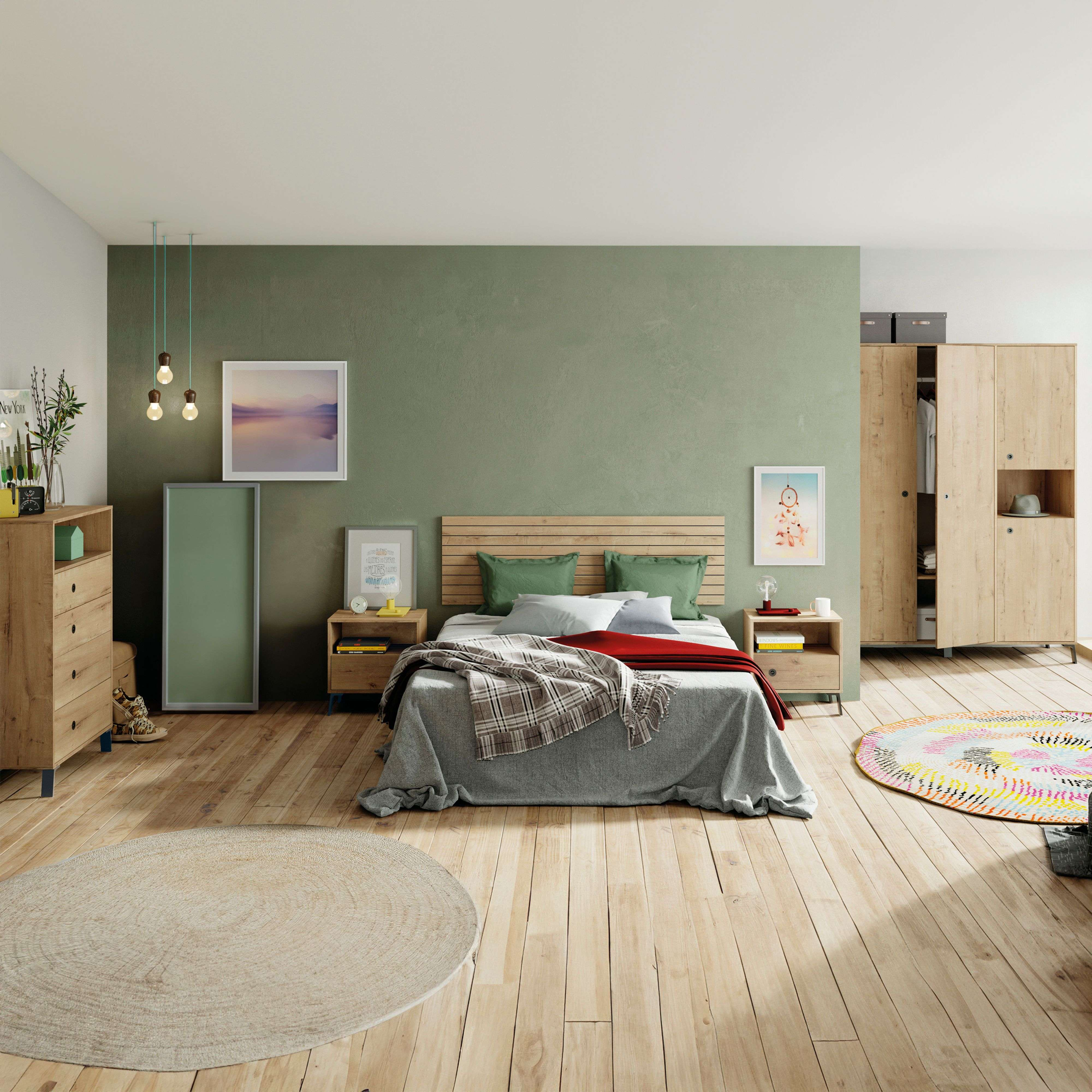 Un dormitorio con suelo de madera, cama de madera, armario y alfombras coloridas.