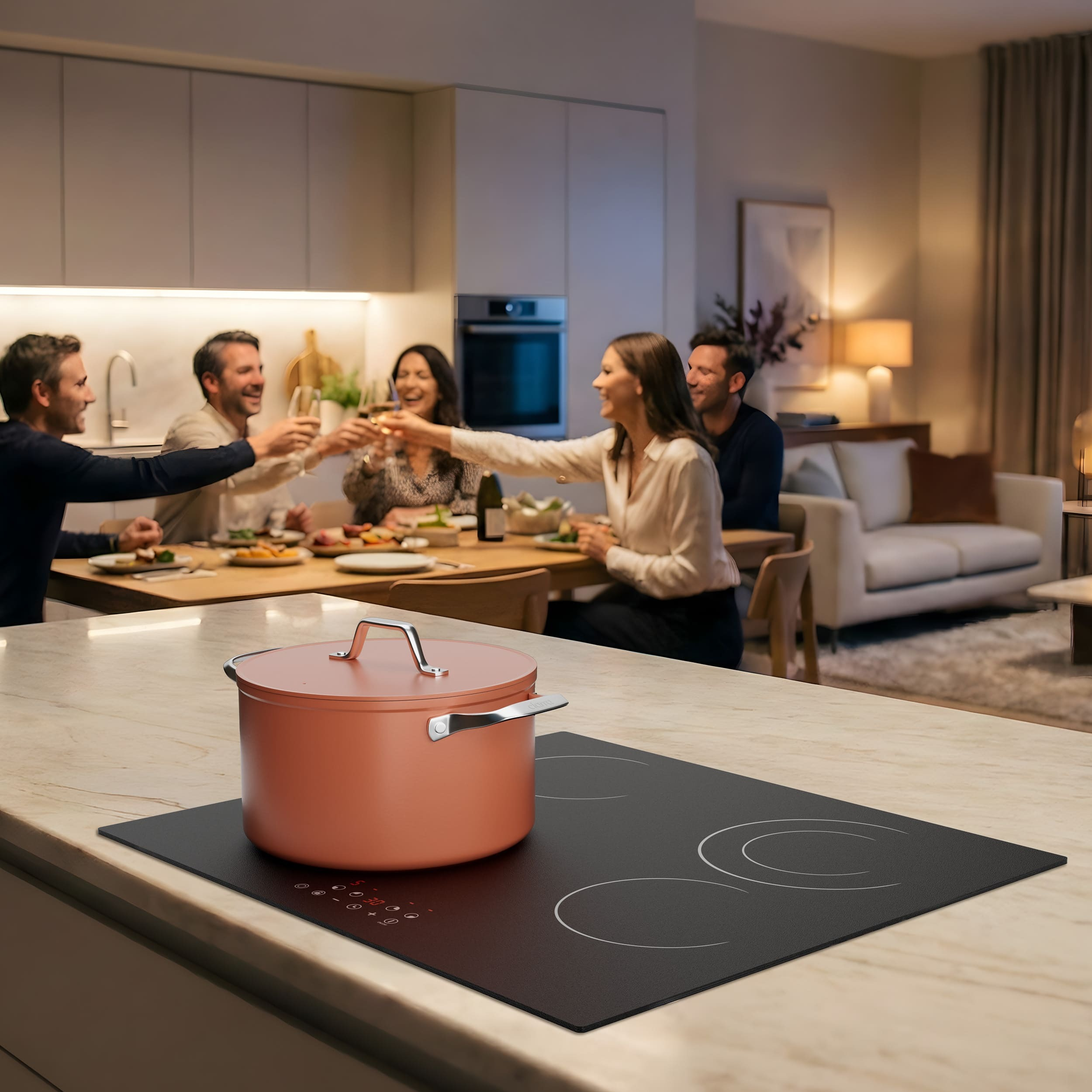 A copper pot on an induction hob in a modern kitchen, guests celebrate at a table.