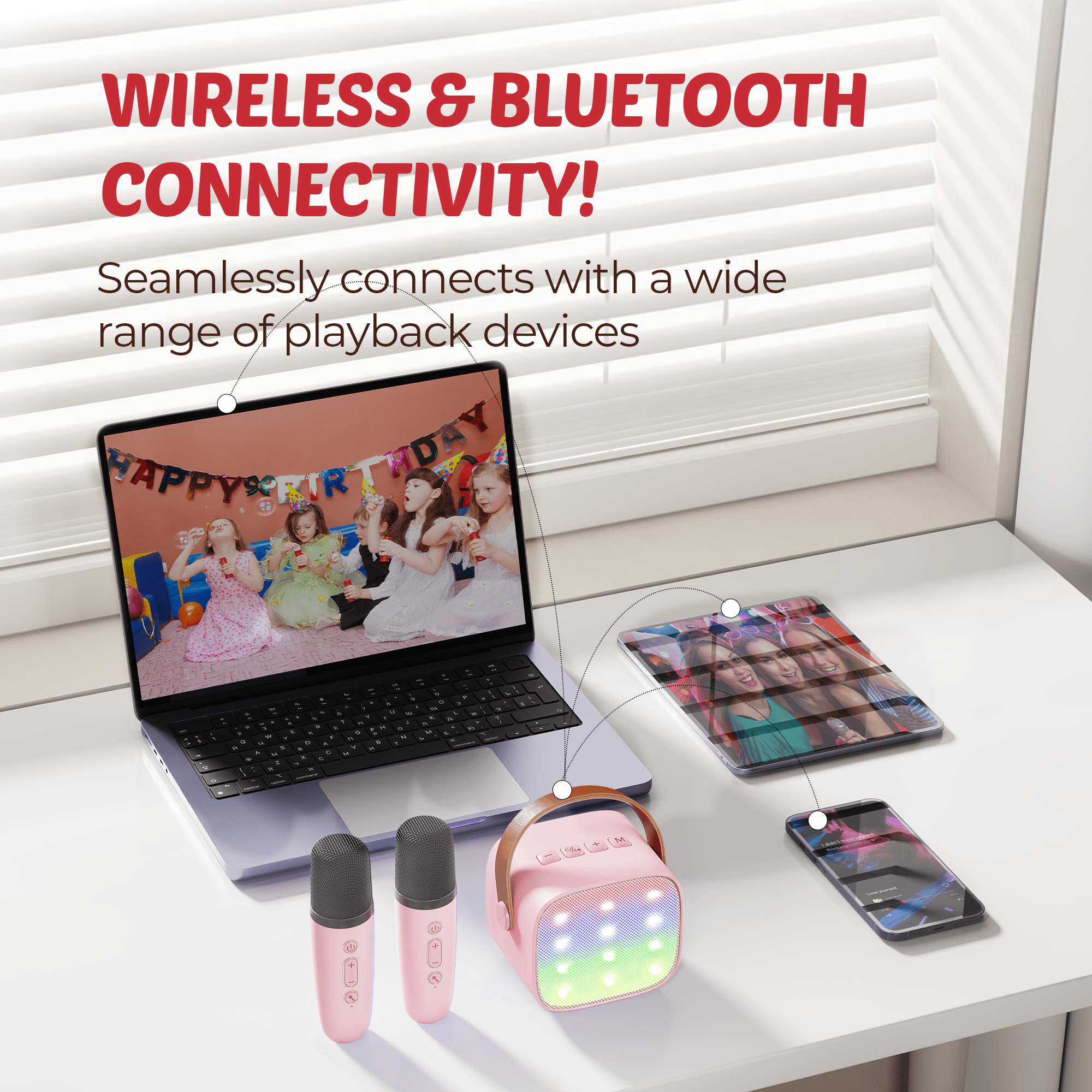 Ein rosa Bluetooth-Lautsprecher mit Lichtern, zwei Mikrofonen, Laptop, Tablet und Handy.