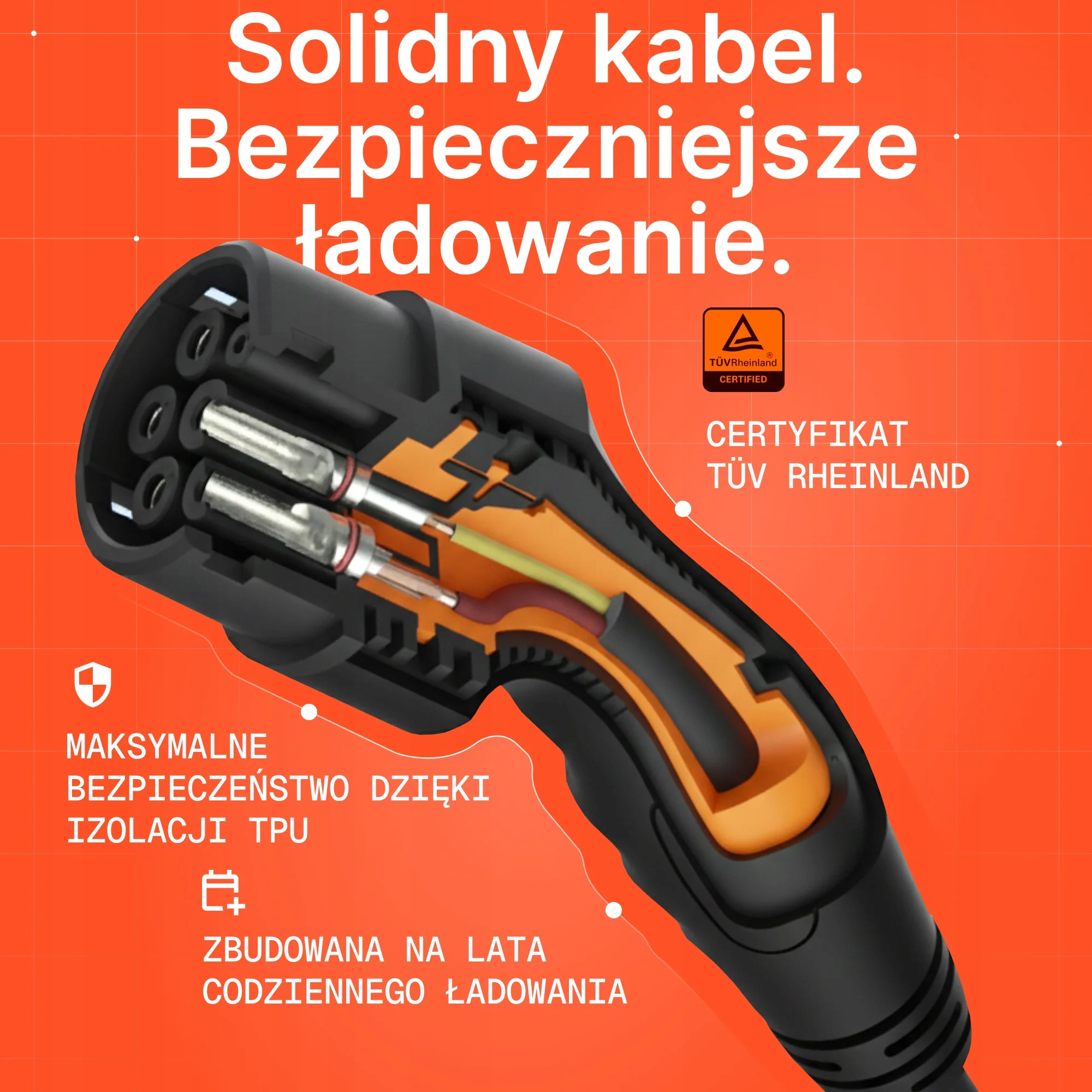 Przekrój kabla ładowania ze srebrnymi pinami i pomarańczową izolacją.