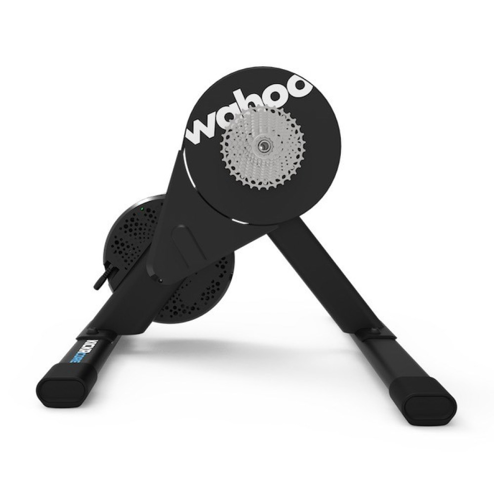 Un trainer per bici smart Wahoo Kickr nero con cassetta e gambe.