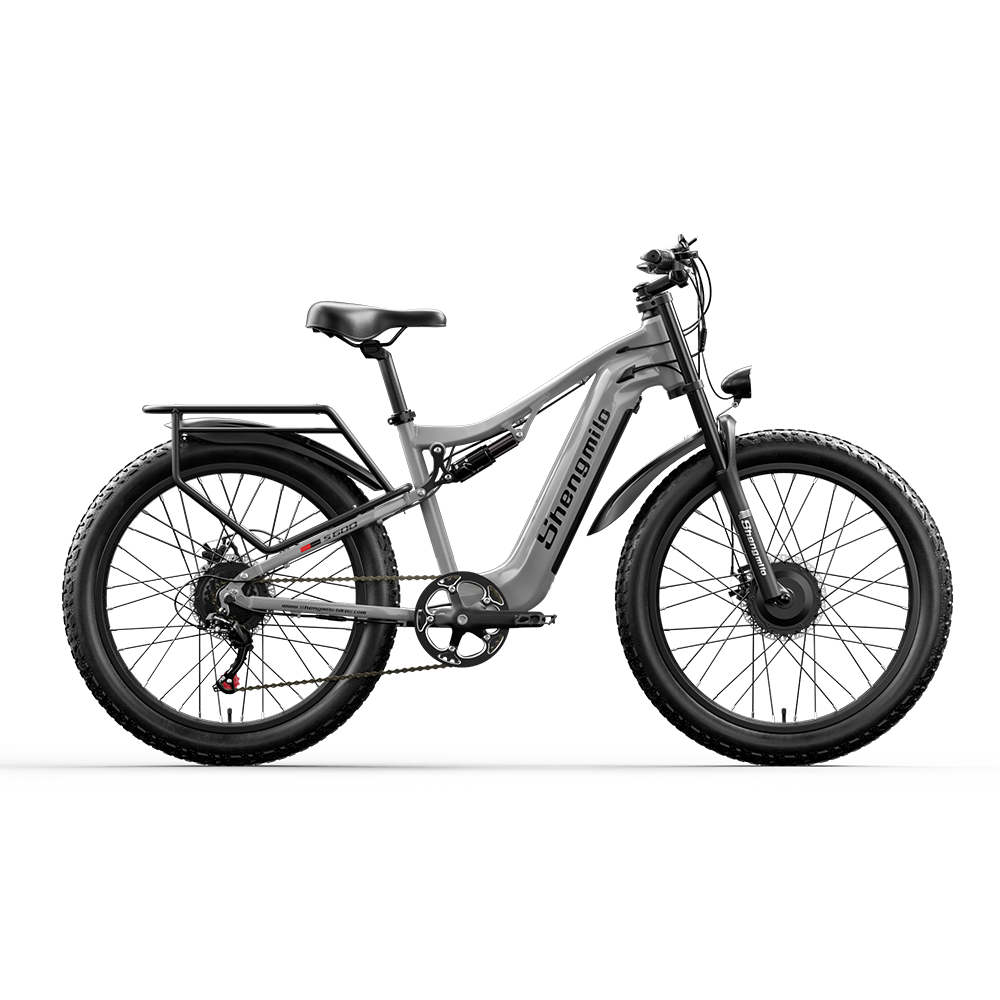 Graues E-Bike mit breiten Reifen, Federung und Gepäckträger.