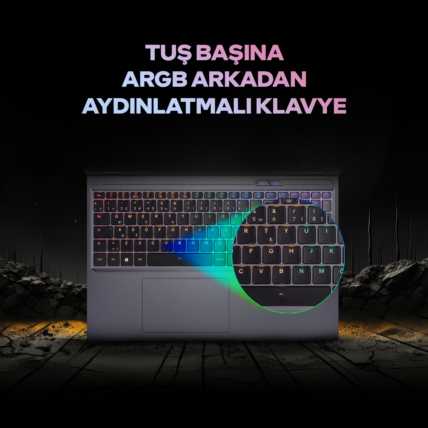 Koyu, kayalık bir ortamda ARGB arkadan aydınlatmalı klavyeli dizüstü bilgisayar.