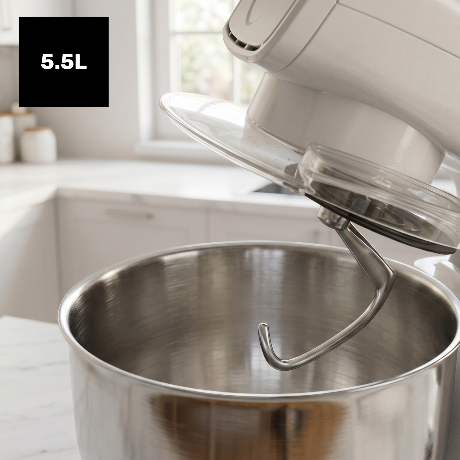 Un robot de cocina blanco con un bol grande de acero inoxidable y gancho.