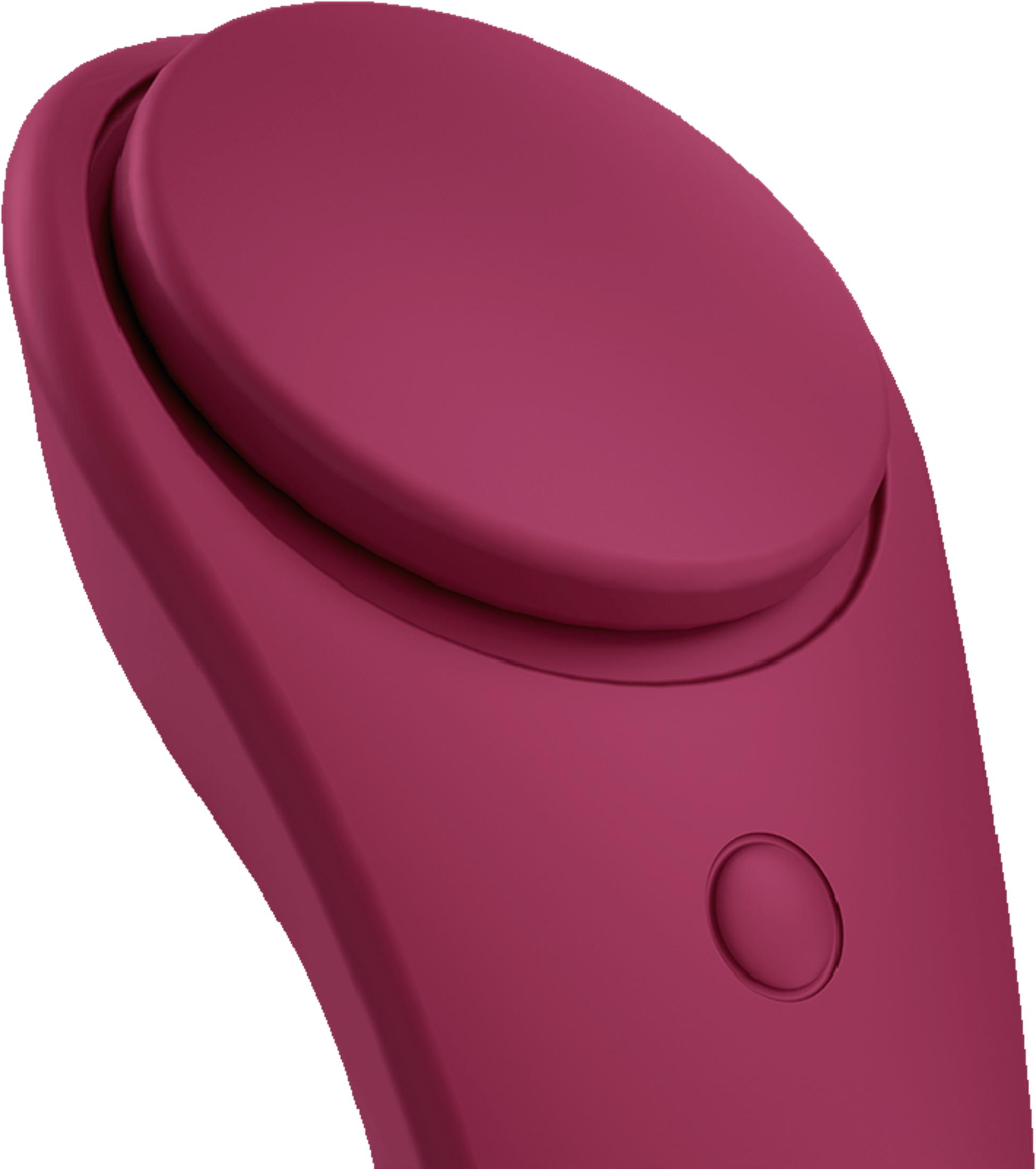 Różowe urządzenie z okrągłym przyciskiem i małym kółkiem.