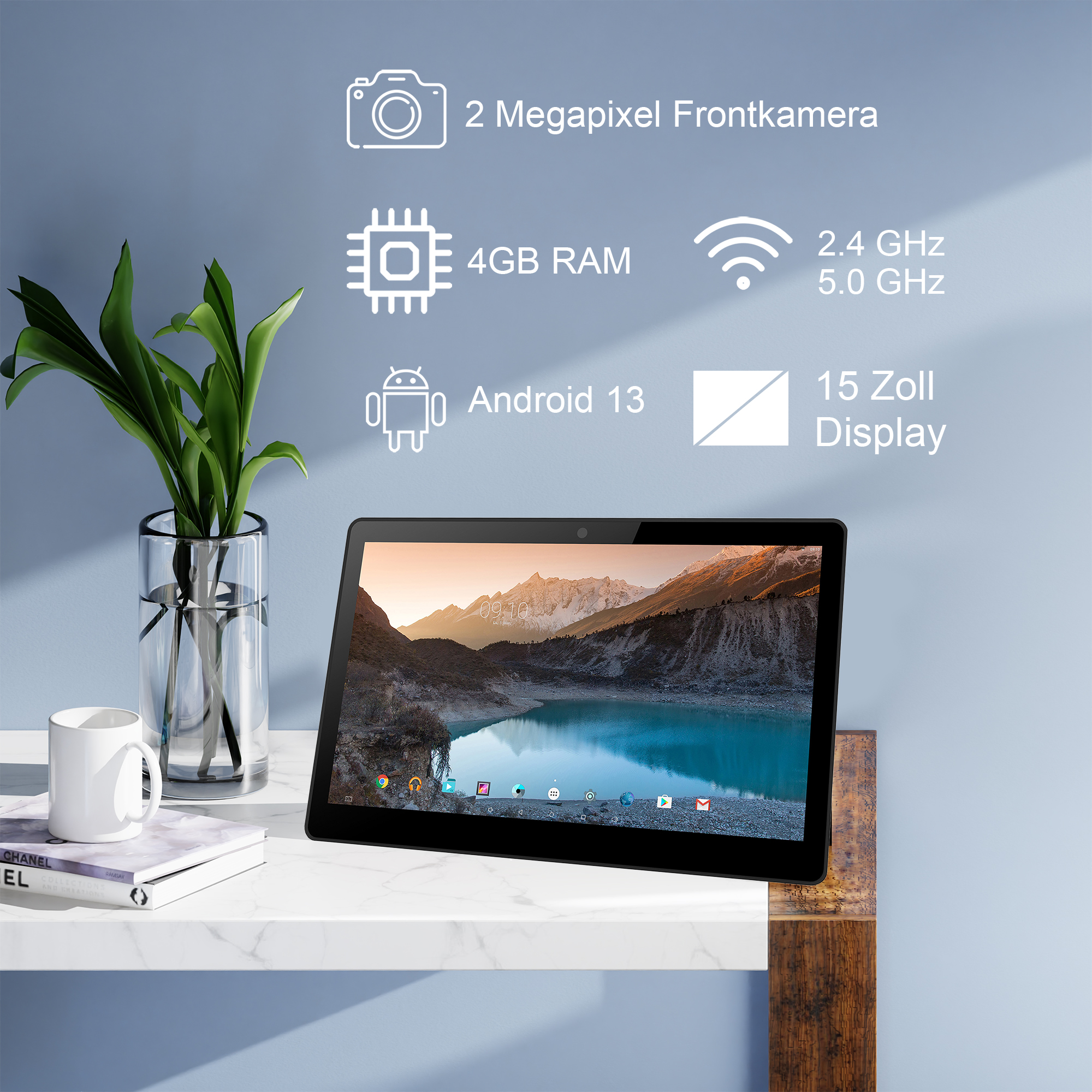Un tablet con paesaggio montano, accanto a pianta e tazza.