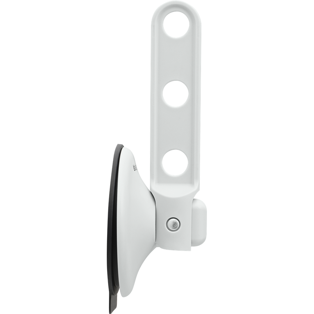 White suction cup holder with three round cutouts.