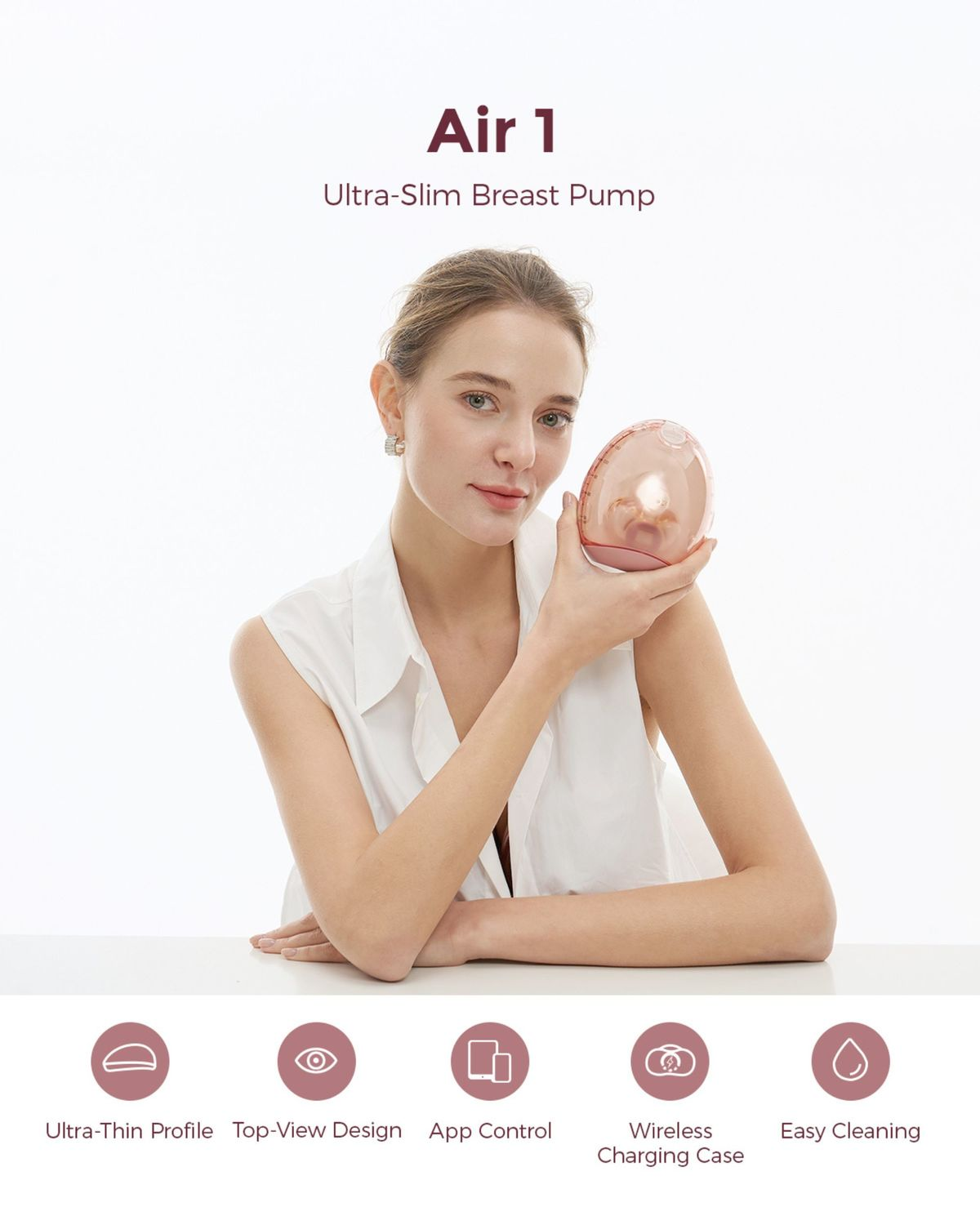 Eine Frau hält eine rosafarbene Milchpumpe. Air 1 Ultra-Slim Brustpumpe.