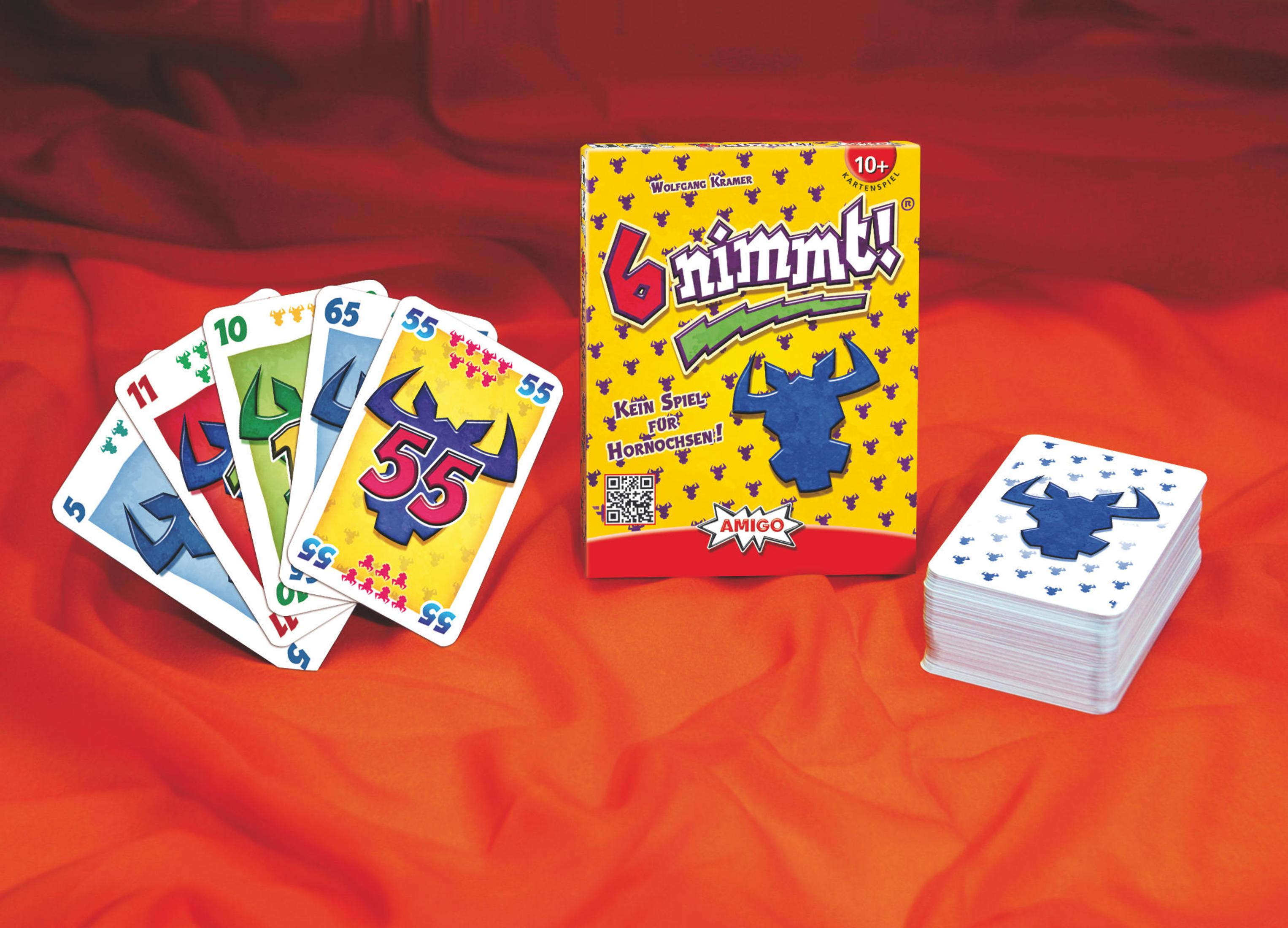Spielkarten und Spielschachtel von "6 Nimmt!" auf rotem Stoff.
