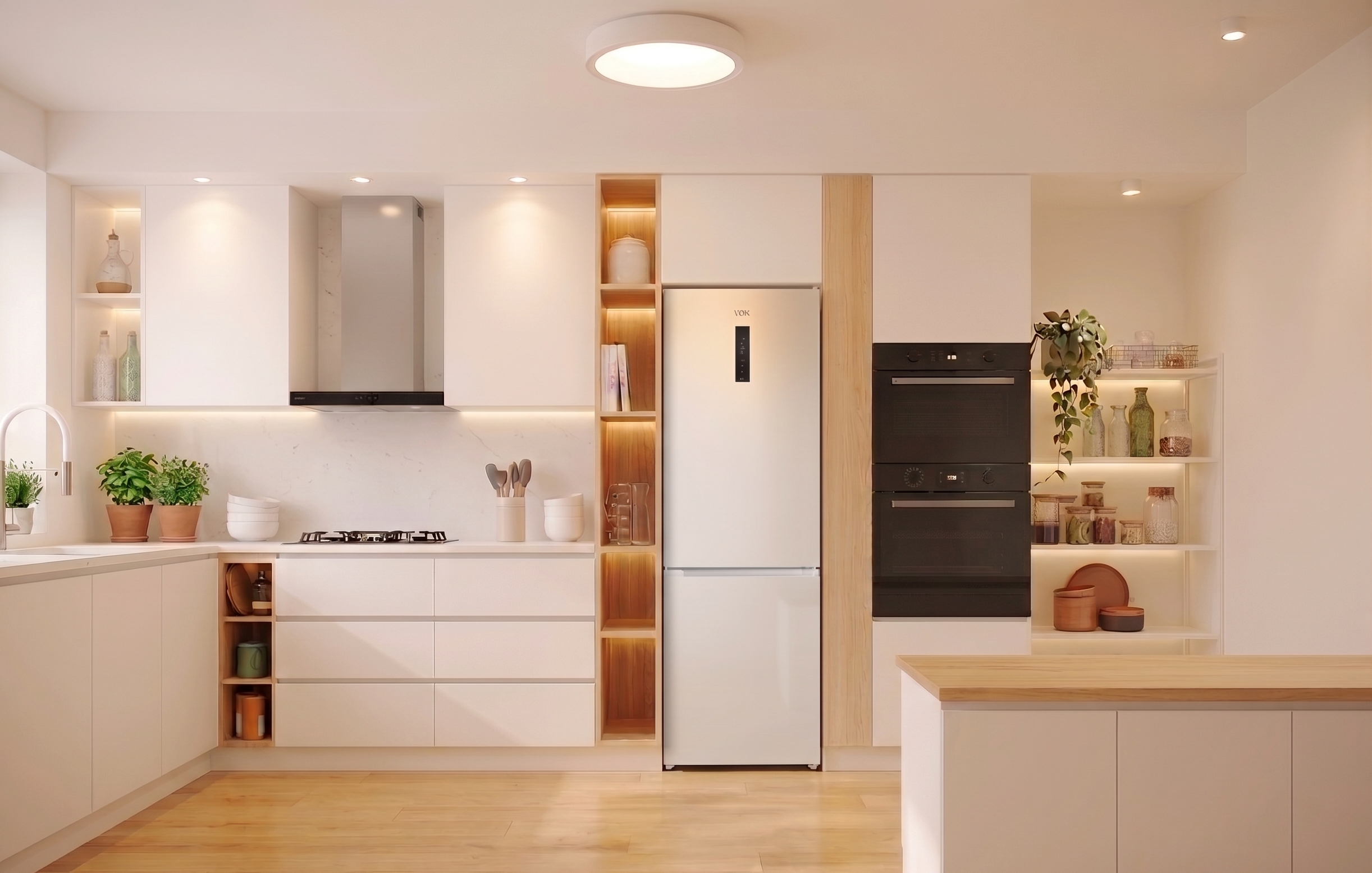 Moderna cocina blanca con refrigerador, hornos, estufa y estantes de madera.