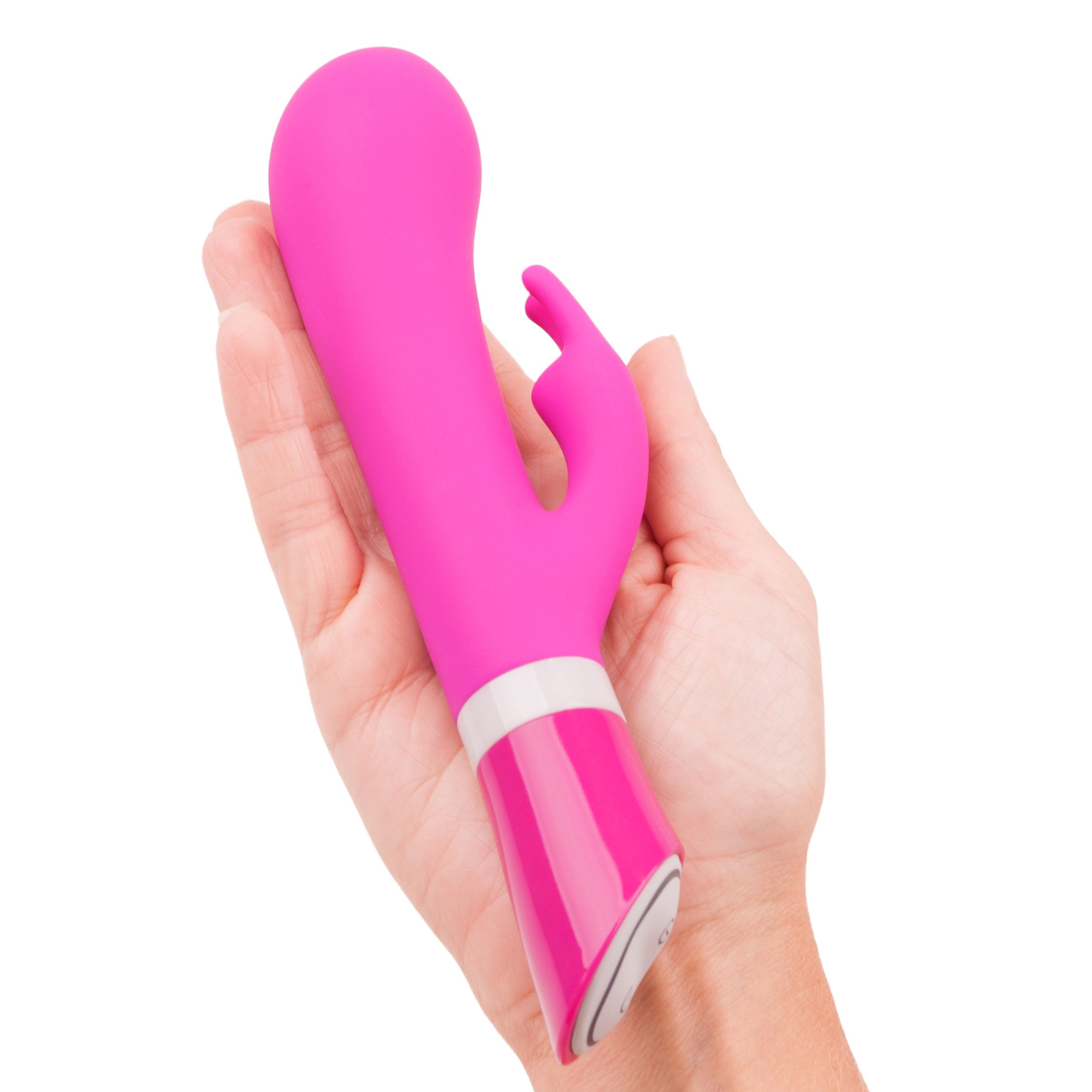 Eine Hand hält einen leuchtend pinken Vibrator mit weißen Akzenten.