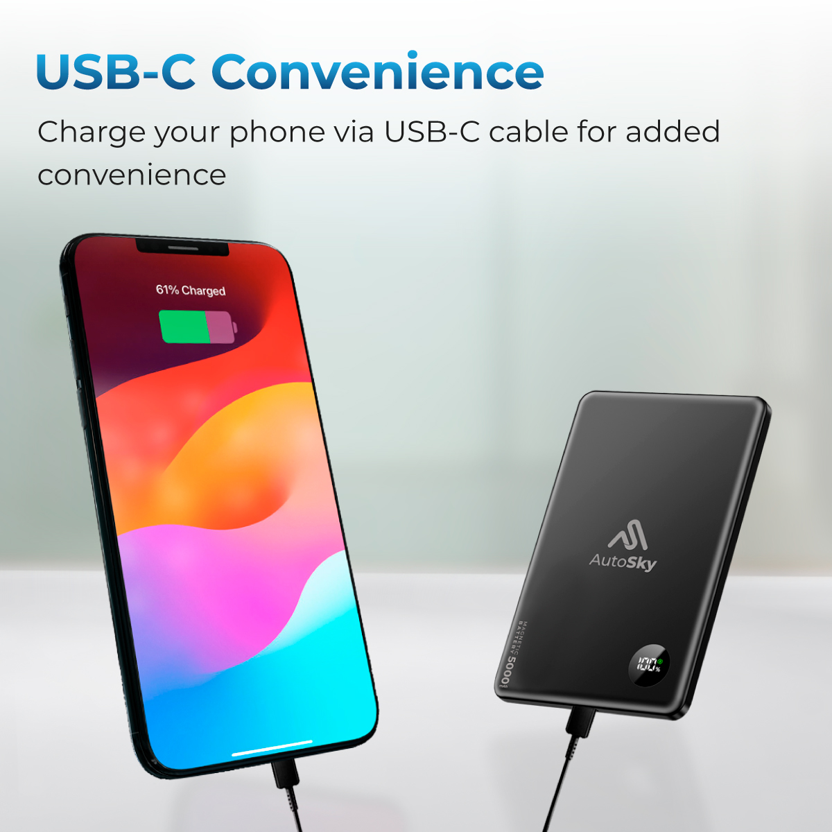 Un smartphone se carga por cable USB-C, junto a él un power bank.