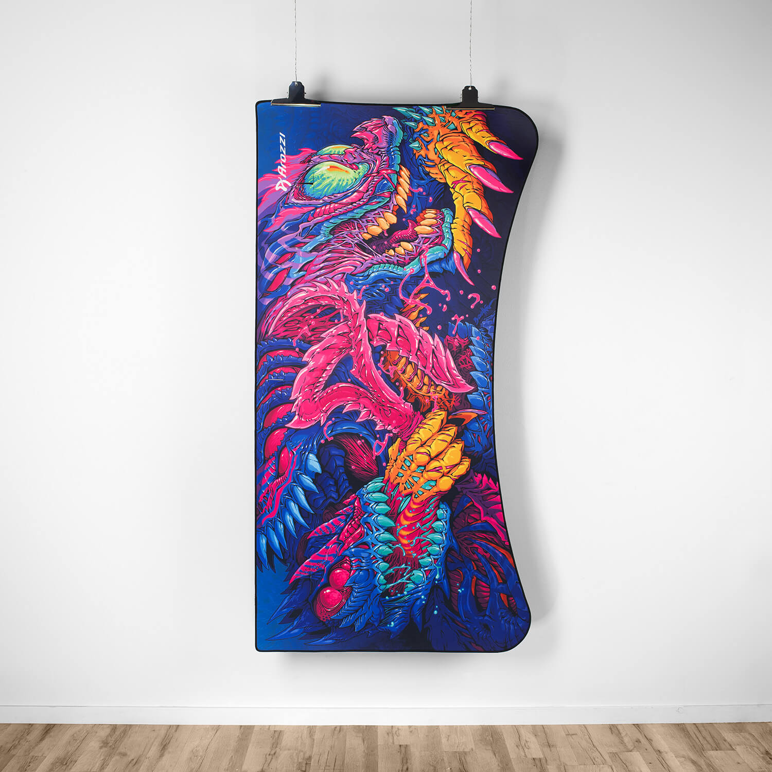 A colorful, digital artwork of a monster hangs on a white wall.