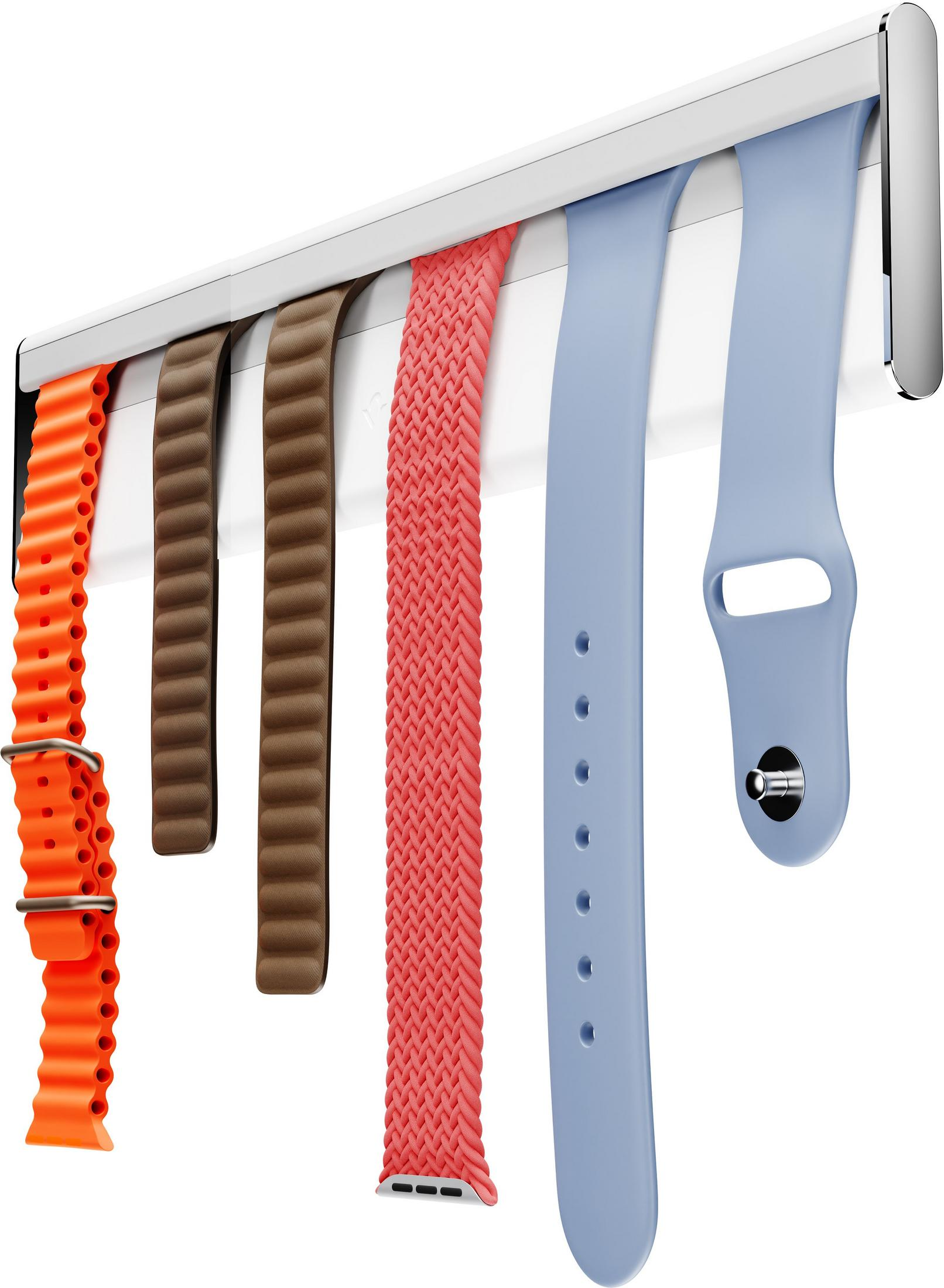 Fünf farbige Uhrenarmbänder, die an einer weißen Halterung hängen.