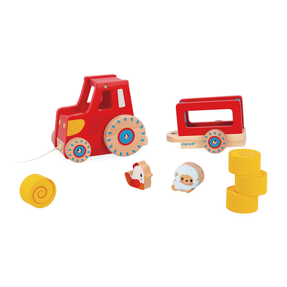 Ein roter Spielzeugtraktor mit Anhänger, Huhn, Schaf und Holzblöcken.
