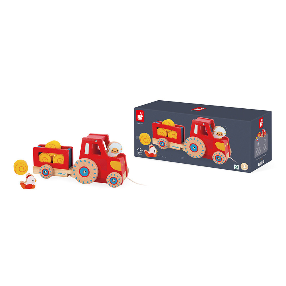 Ein roter Holztrecker mit Anhänger, der Holztiere und Ballen transportiert.