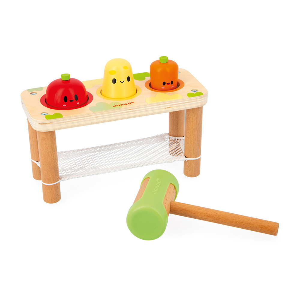 Holzspielzeug mit drei Obst- und Gemüsepüppchen und einem Hammer auf weißem Hintergrund.