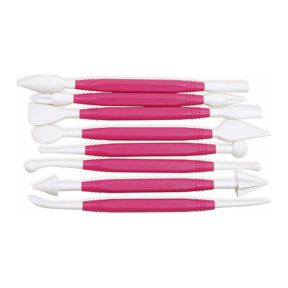 Ein Set weißer Fondantwerkzeuge mit pinken Griffen liegt horizontal.