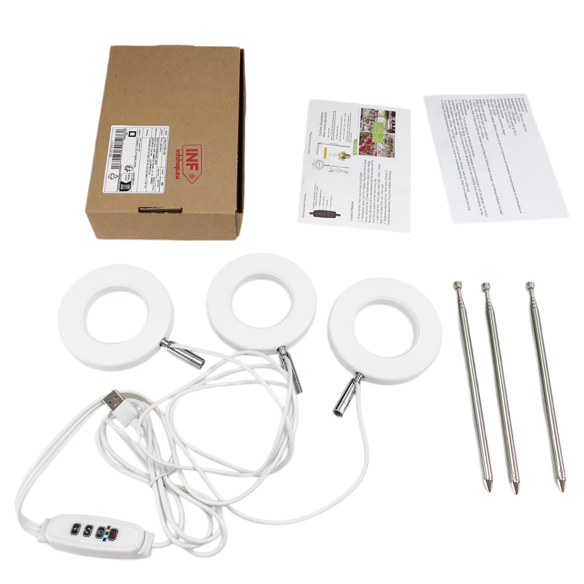 Una scatola, tre luci ad anello, un controller USB e tre picchetti di terra su sfondo bianco.