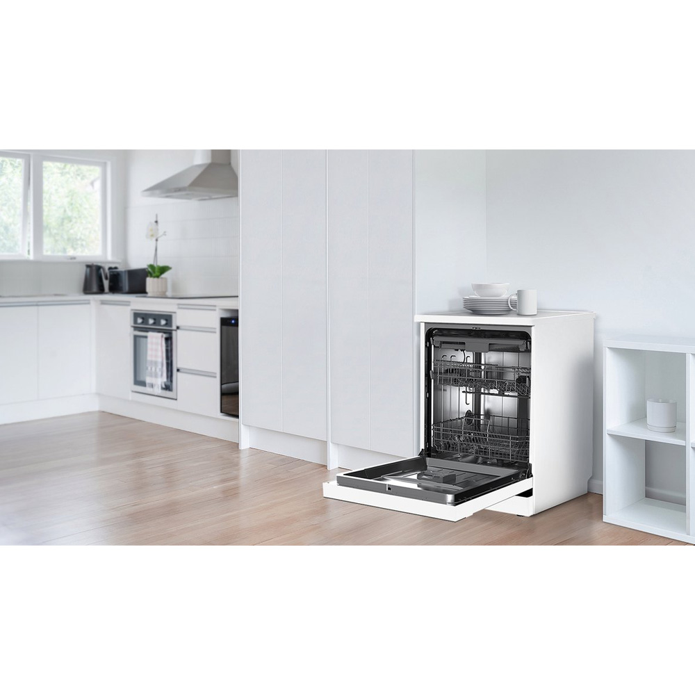 A white dishwasher with its door open in a modern kitchen setting.