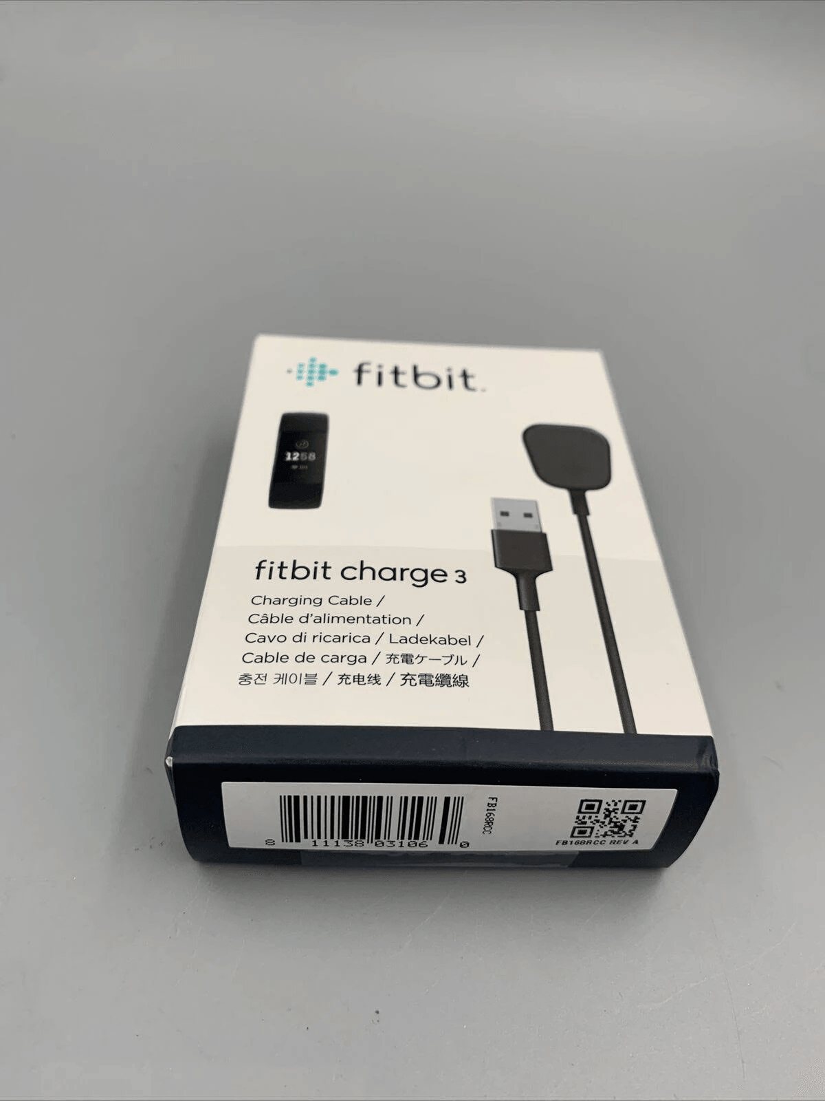 Caja de cable de carga Fitbit Charge 3 con cable USB y cargador.