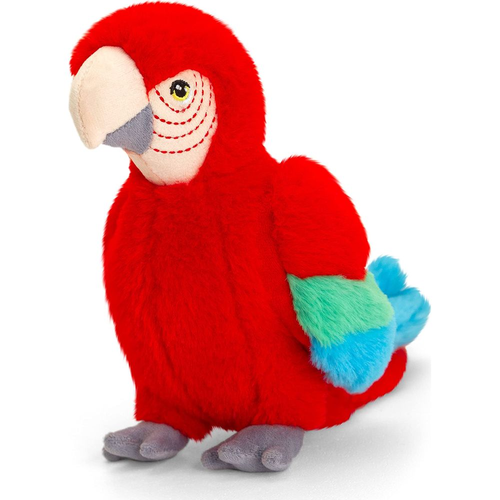 Ein roter Plüschara mit blauen und grünen Flügelspitzen und grauen Füßen.
