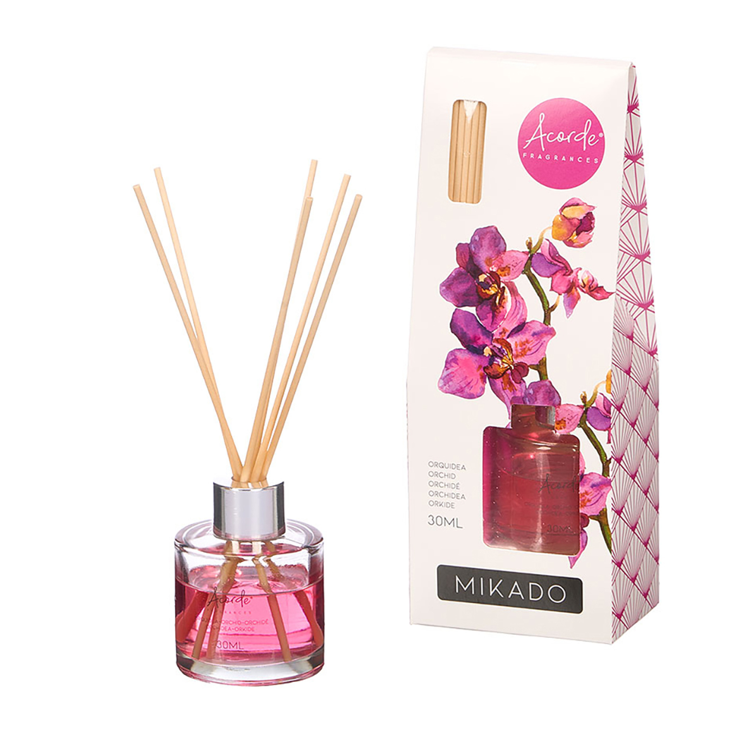 Vidrio con líquido difusor rosa y varillas, al lado de caja con diseño de orquídea.