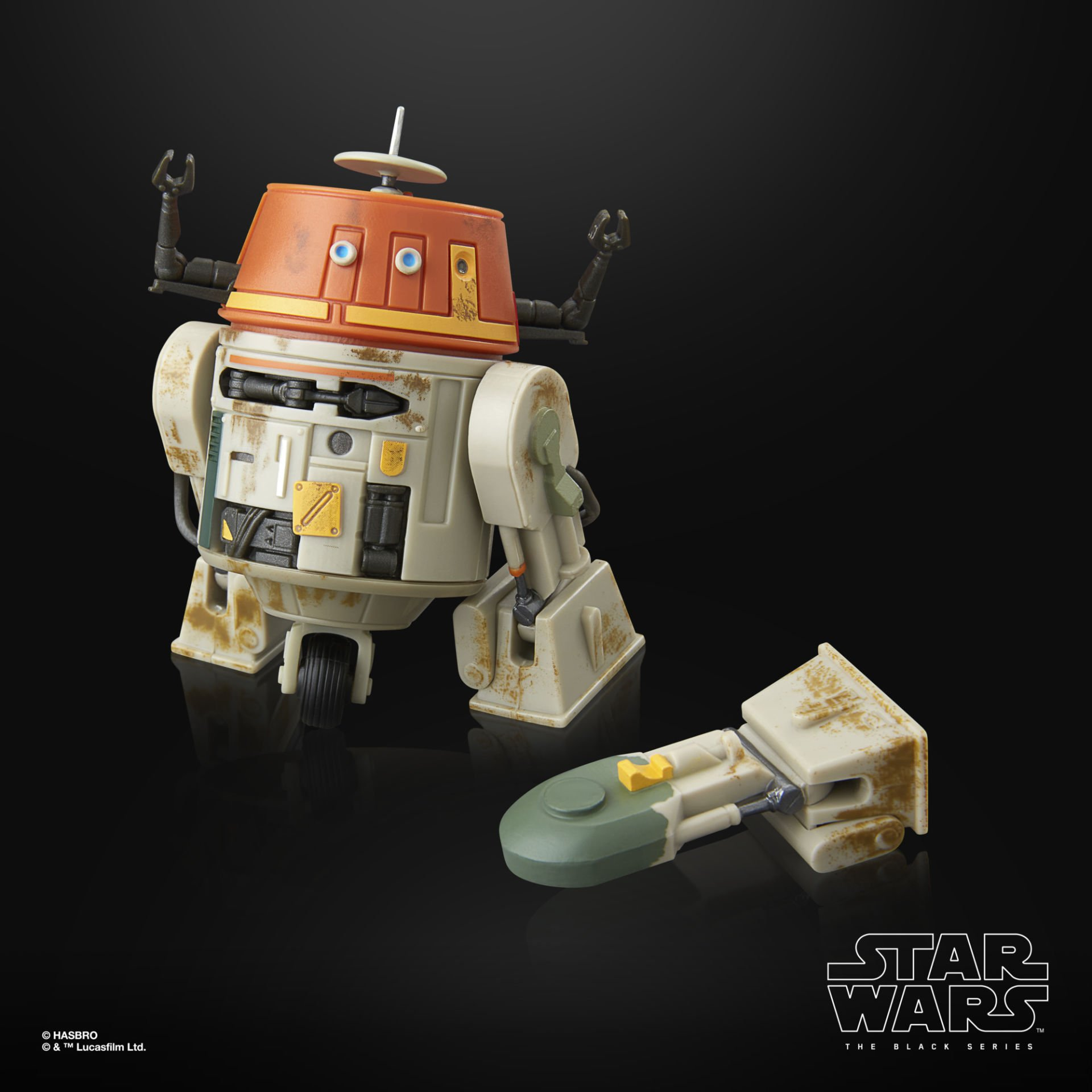 Un droide astromecánico beige con cabeza naranja y dos brazos está junto a una pieza desmontable.