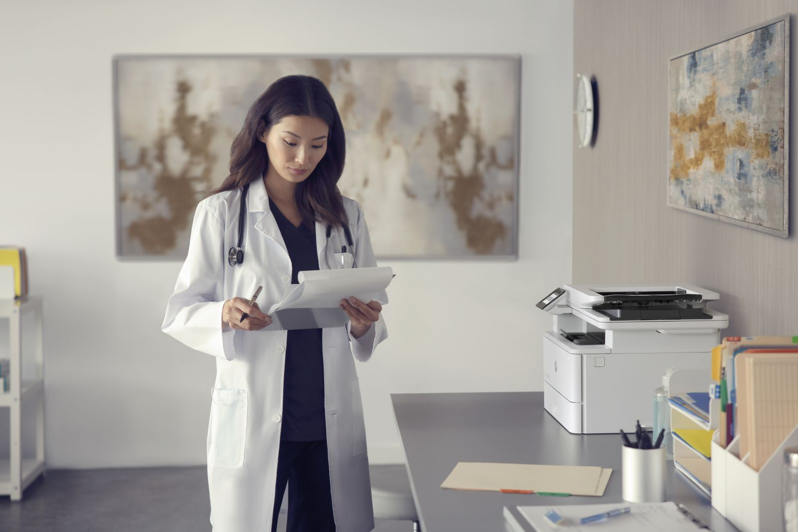 Lekarka w białym fartuchu trzyma teczkę i długopis w biurze.