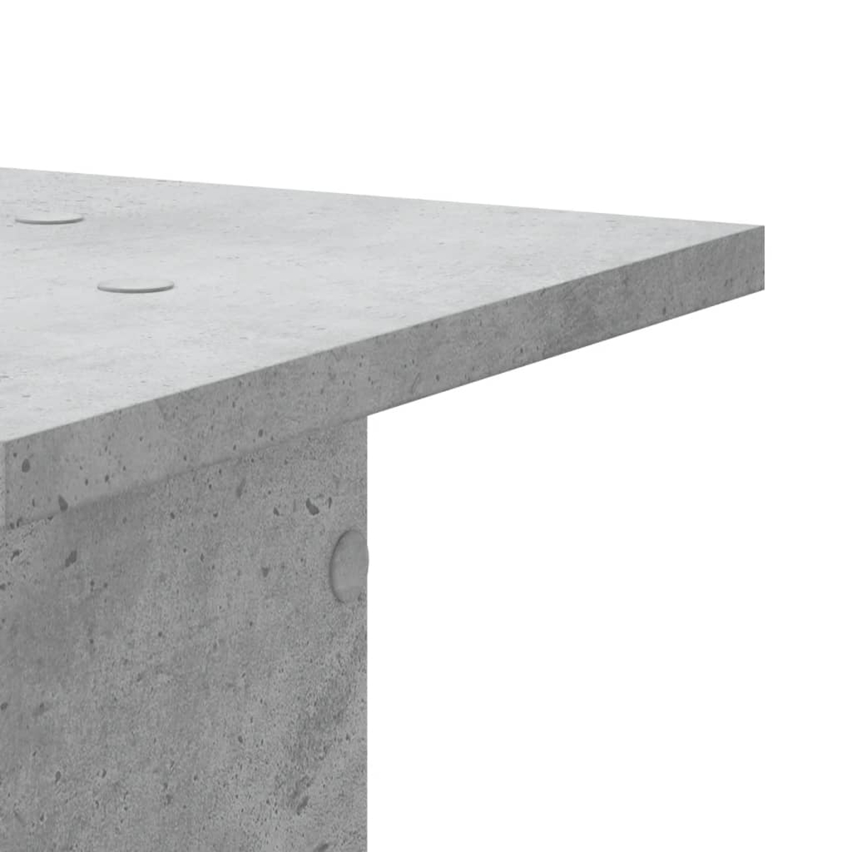 Grauer Beton-Tisch mit runden Aussparungen.