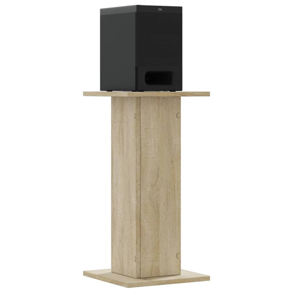 Ein schwarzer Subwoofer steht auf einem hölzernen TV-Ständer.