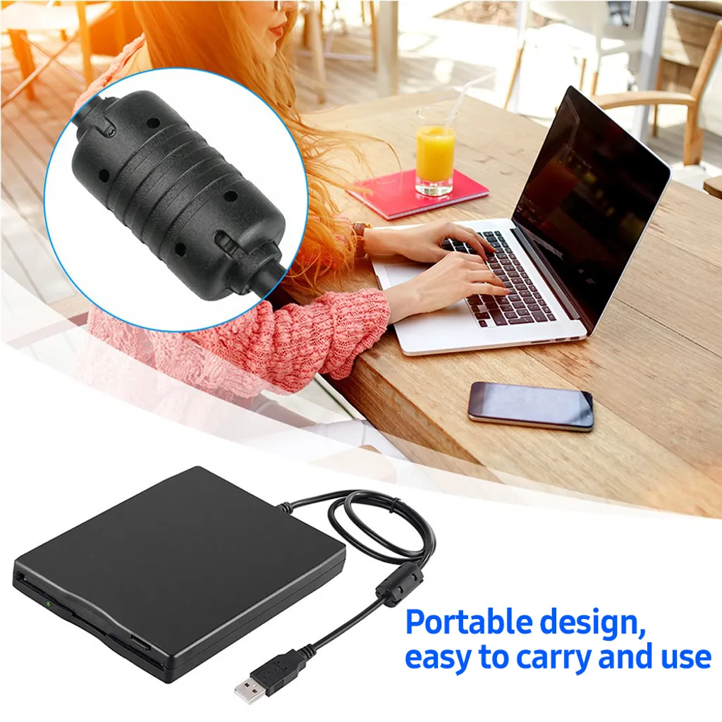 Ein schwarzes externes Diskettenlaufwerk mit USB-Kabel liegt auf einem Holztisch.