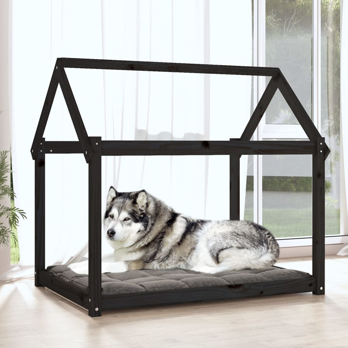 Ein Husky liegt auf einem Kissen in einem Holzhaus für Haustiere.